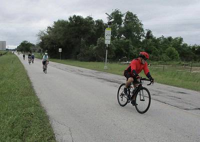 Cyclists riding on a rural road during a bike trail event.