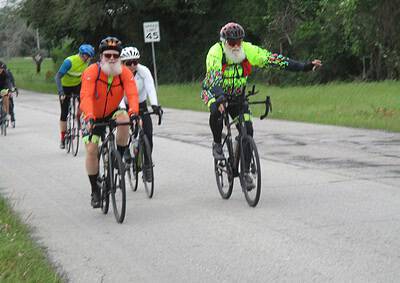 Vibrant cyclists riding on scenic route with Bluebonnet Express branding, promoting group biking events and outdoor activity.