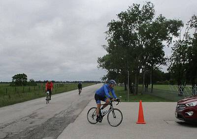 Bicycle riders on the road during Bluebonnet Express event, Texas scenic cycling race.
