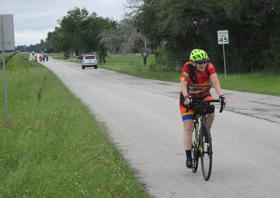 Bright green helmet, colorful cycling jersey, and mountain bike on a suburban road during outdoor bike ride.