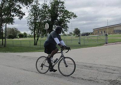 Cyclist riding a bike in an outdoor setting, promoting Bluebonnet Express cycling services and eco-friendly transportation.