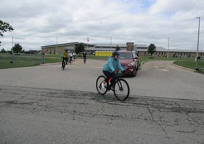 Cyclists riding near Bluebonnet Express School in Texas, showcasing community biking events and local school activities.