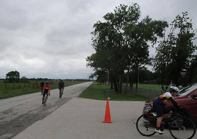 Bike riders on a rural road during an outdoor cycling event at Bluebonnet Express.