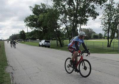 Bike riding on a cloudy day with a group of cyclists near a park in Texas.