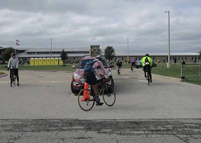 Cyclists at Bluebonnet Express event near a school during daytime.