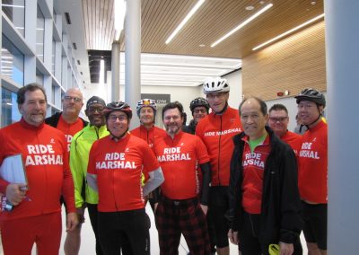 Cycling group in bright red Ride Marshal jerseys at Bluebonnet Express event.