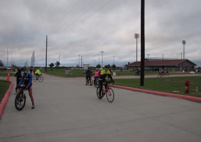 Quiet daytime scene of cyclists riding at Bluebonnet Express bike trail in Texas.