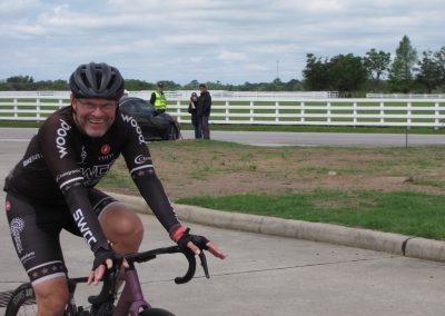 Vibrant cyclist enjoying Bluebonnet Express bike ride event on scenic Texas roads.