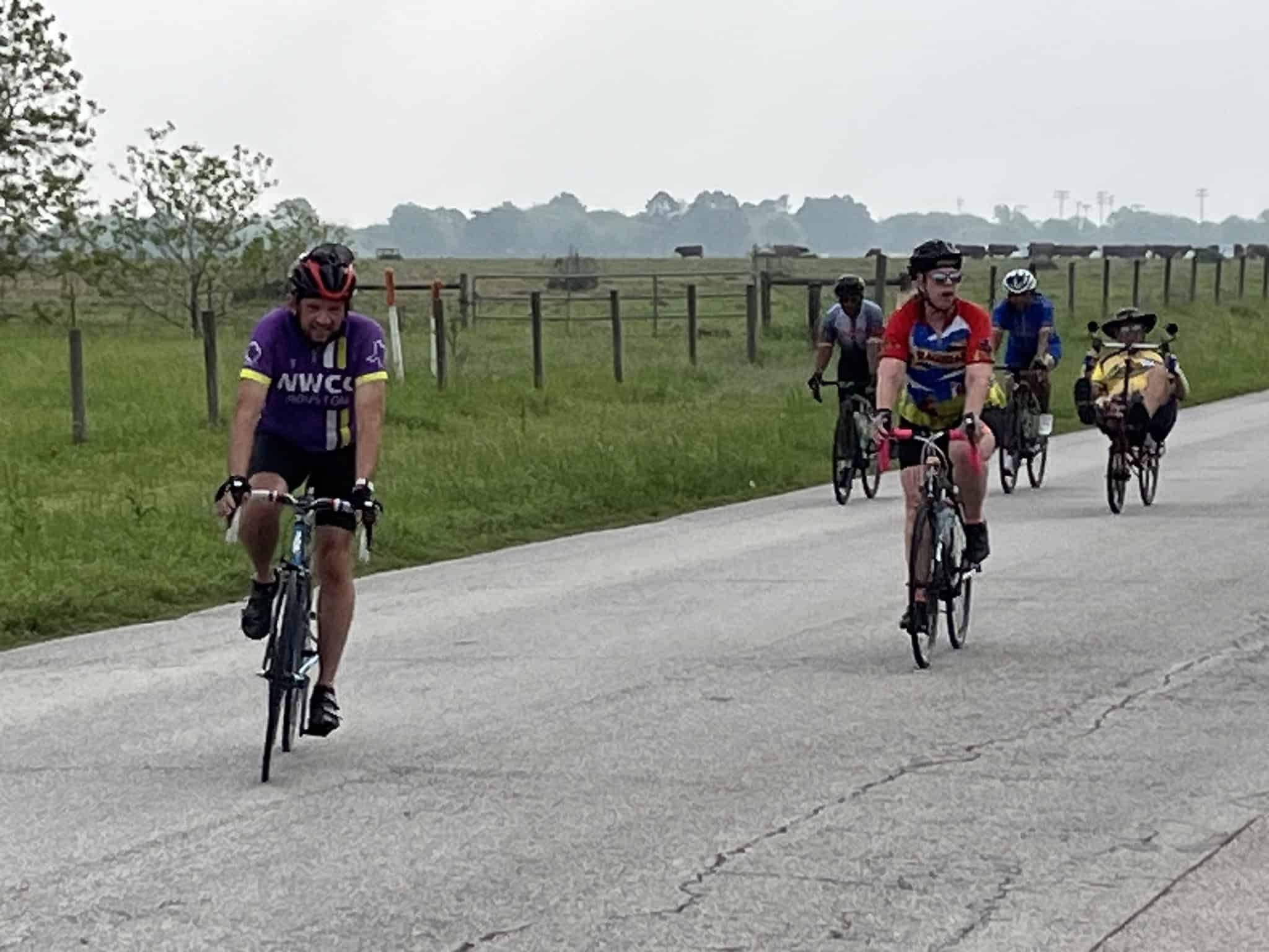 Bicycle riders enjoying scenic ride along open countryside on the Bluebonnet Express route.