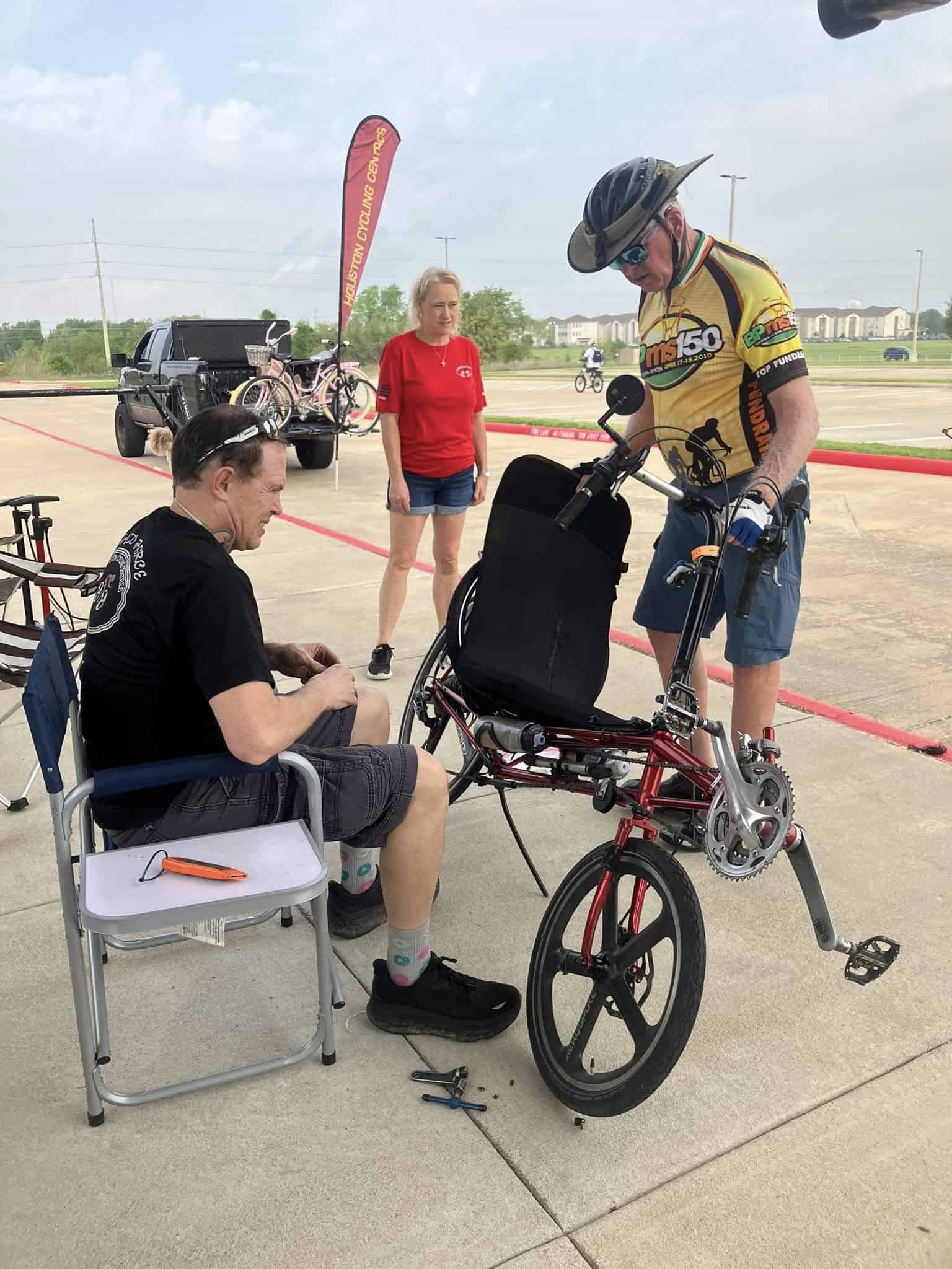 Accessible electric tricycle bike repair at Bluebonnet Express bike event on a sunny day.