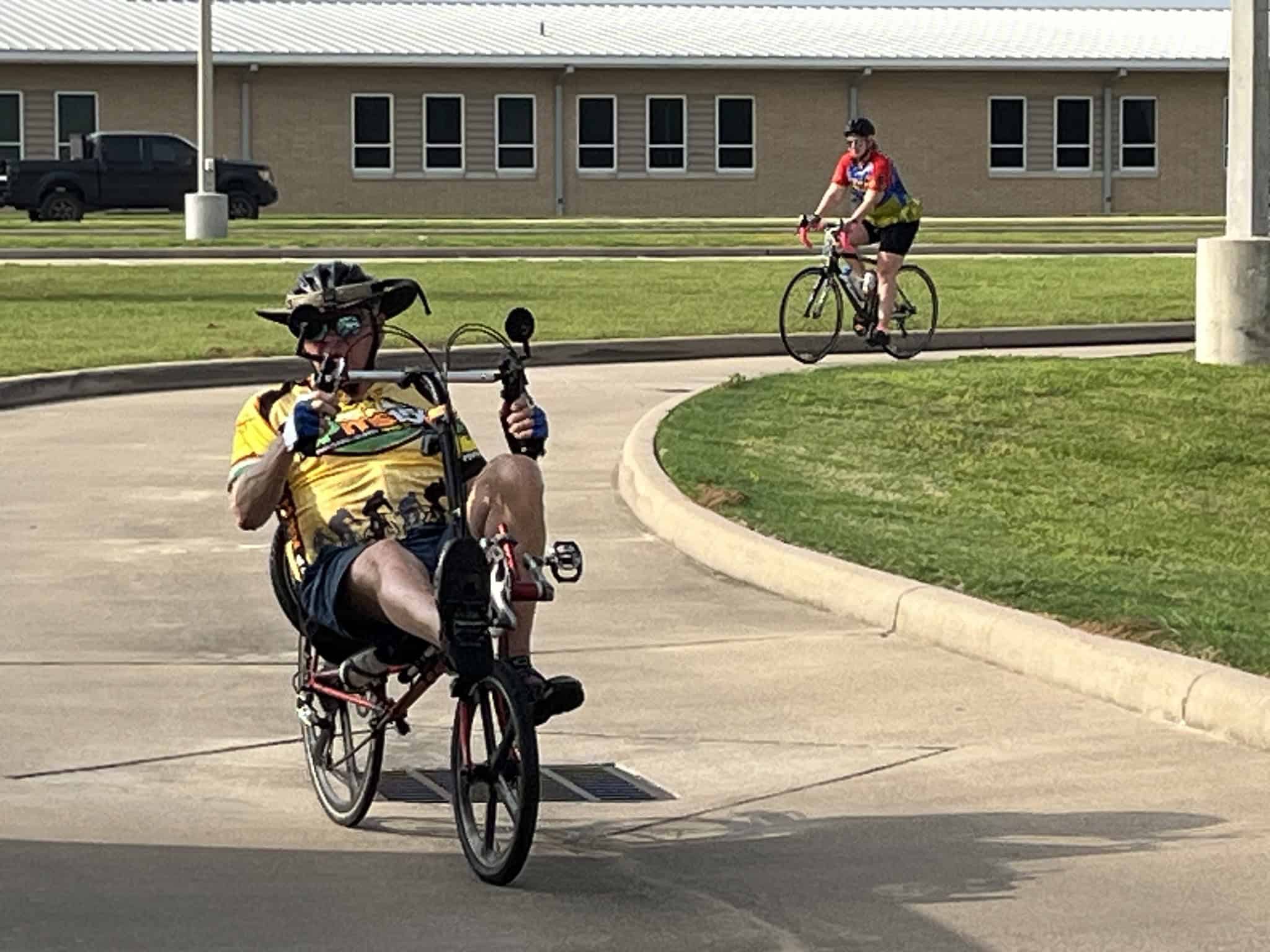 Colorful cyclists riding bikes in a scenic outdoor setting.