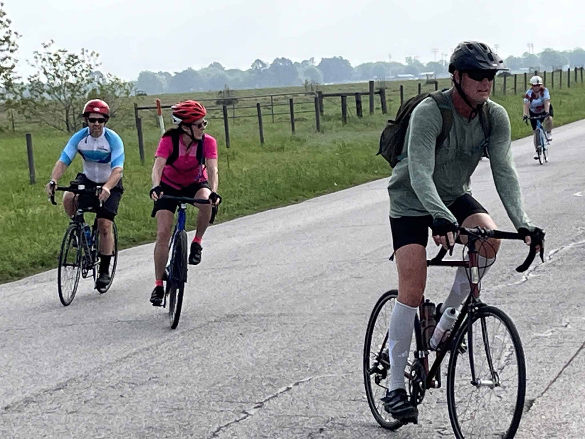 Brightly colored cyclists riding on a scenic trail in Texas during the Bluebonnet season.