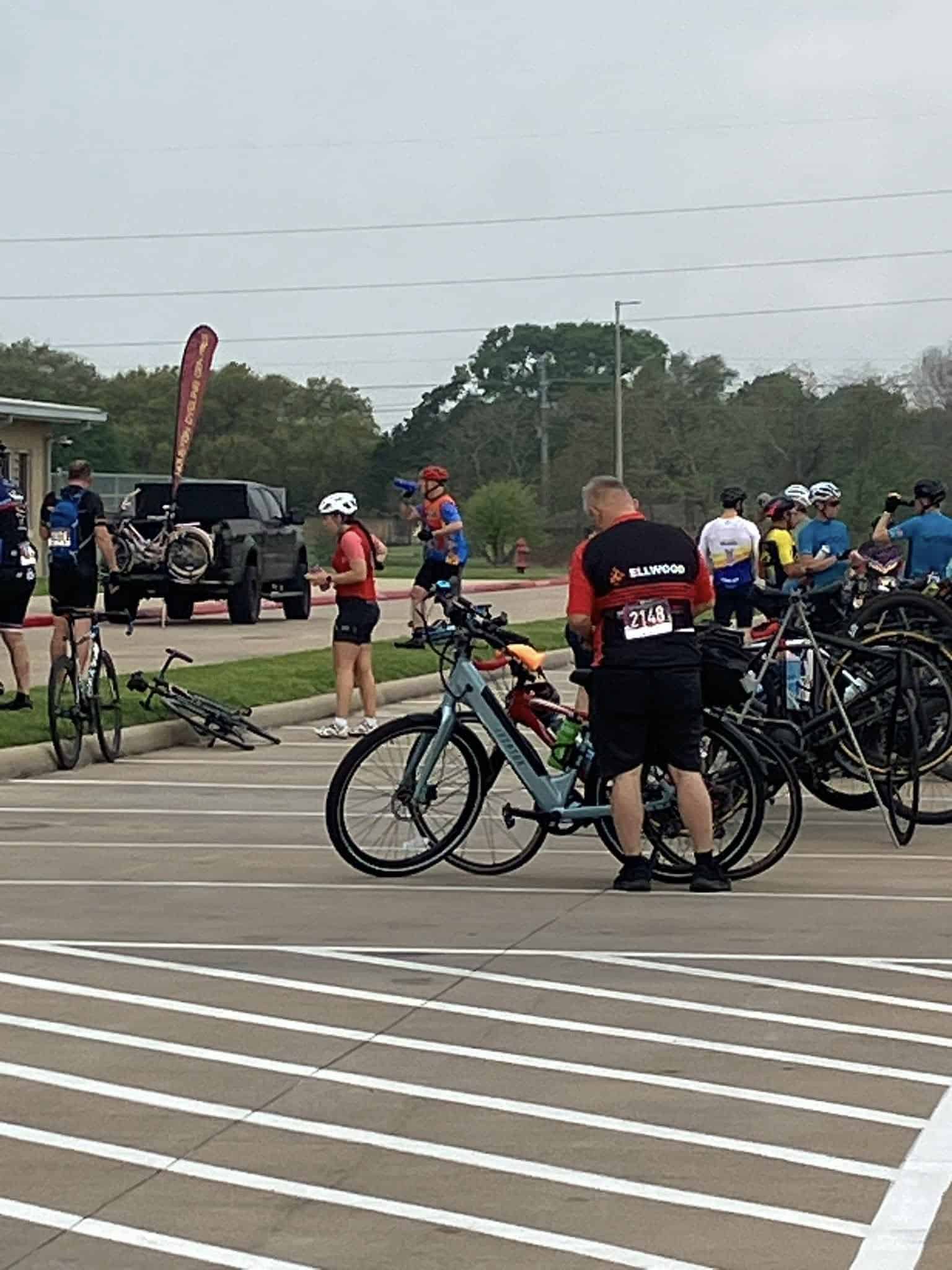 Bicycle event at Bluebonnet Express with cyclists preparing and gathering in a parking lot.