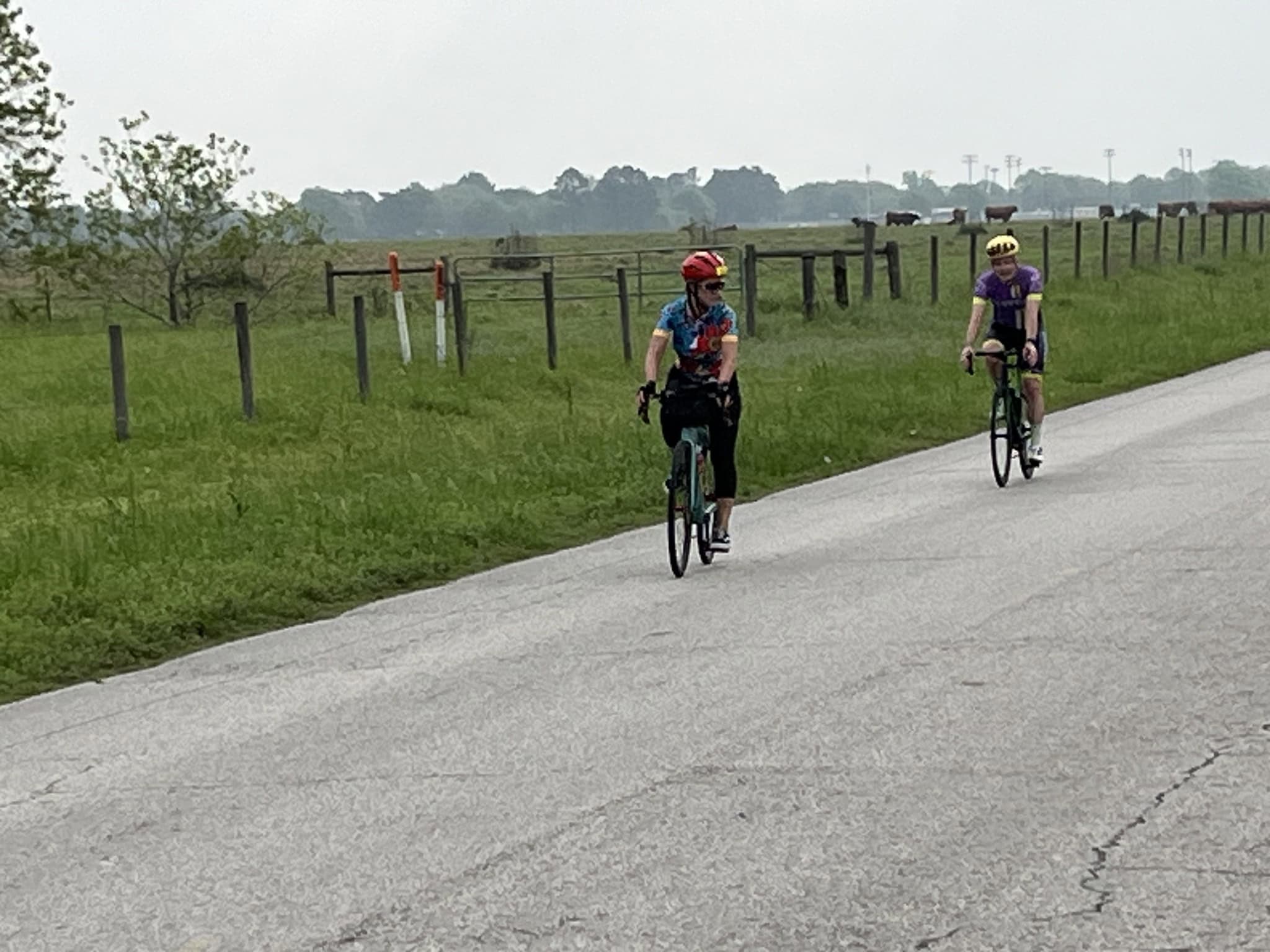 Cyclists enjoying a leisurely ride on a scenic rural bike trail, promoting outdoor fitness on Bluebonnet Express route.