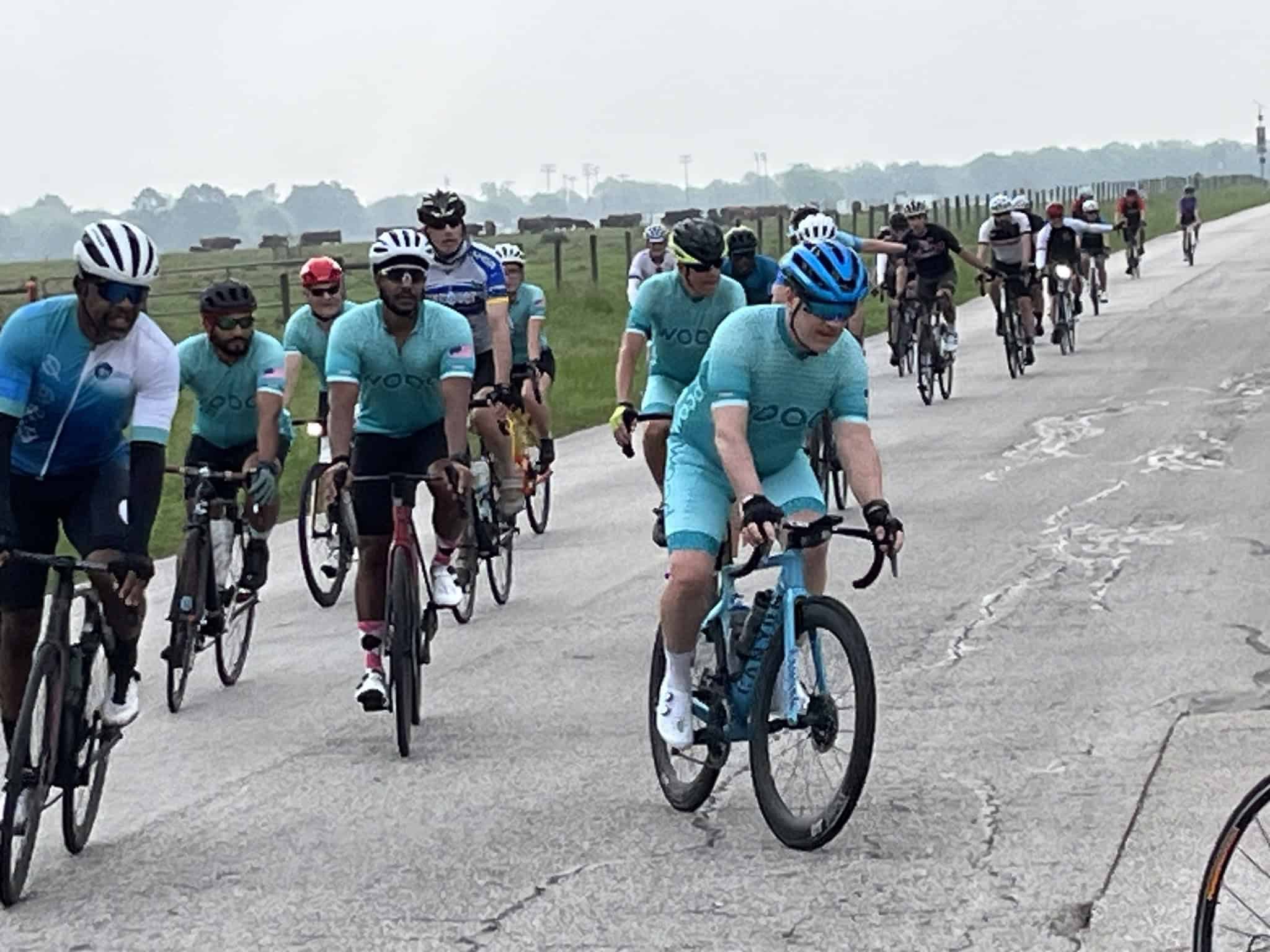 Vibrant group of cyclists participating in the Bluebonnet Express event on a scenic open road.