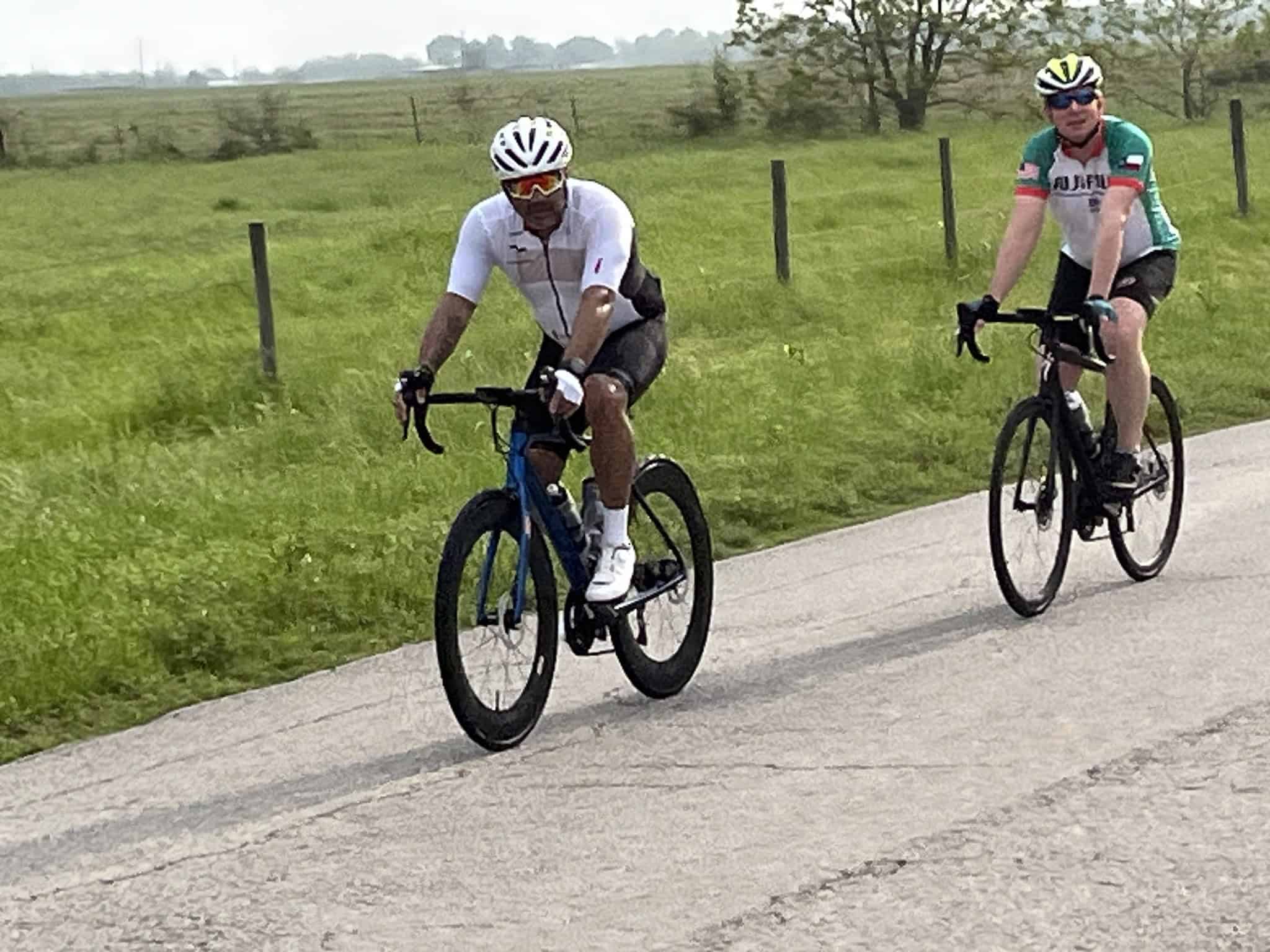 Cyclists riding on a scenic rural road, showcasing outdoor bike adventures and cycling tourism.