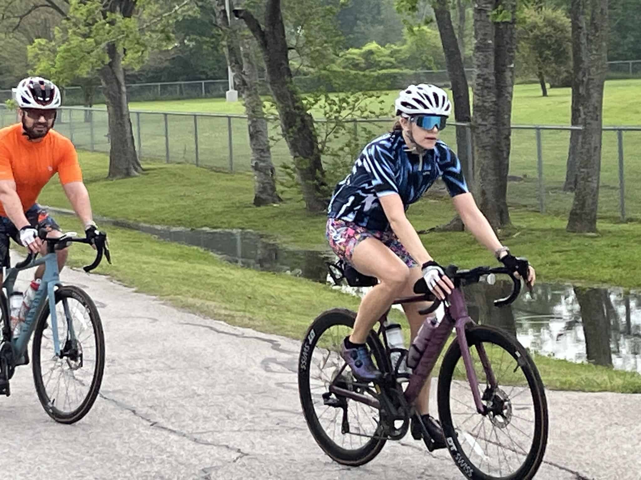 Bright female cyclist riding a gravel bike in Bluebonnet Express race, Texas scenic trail.