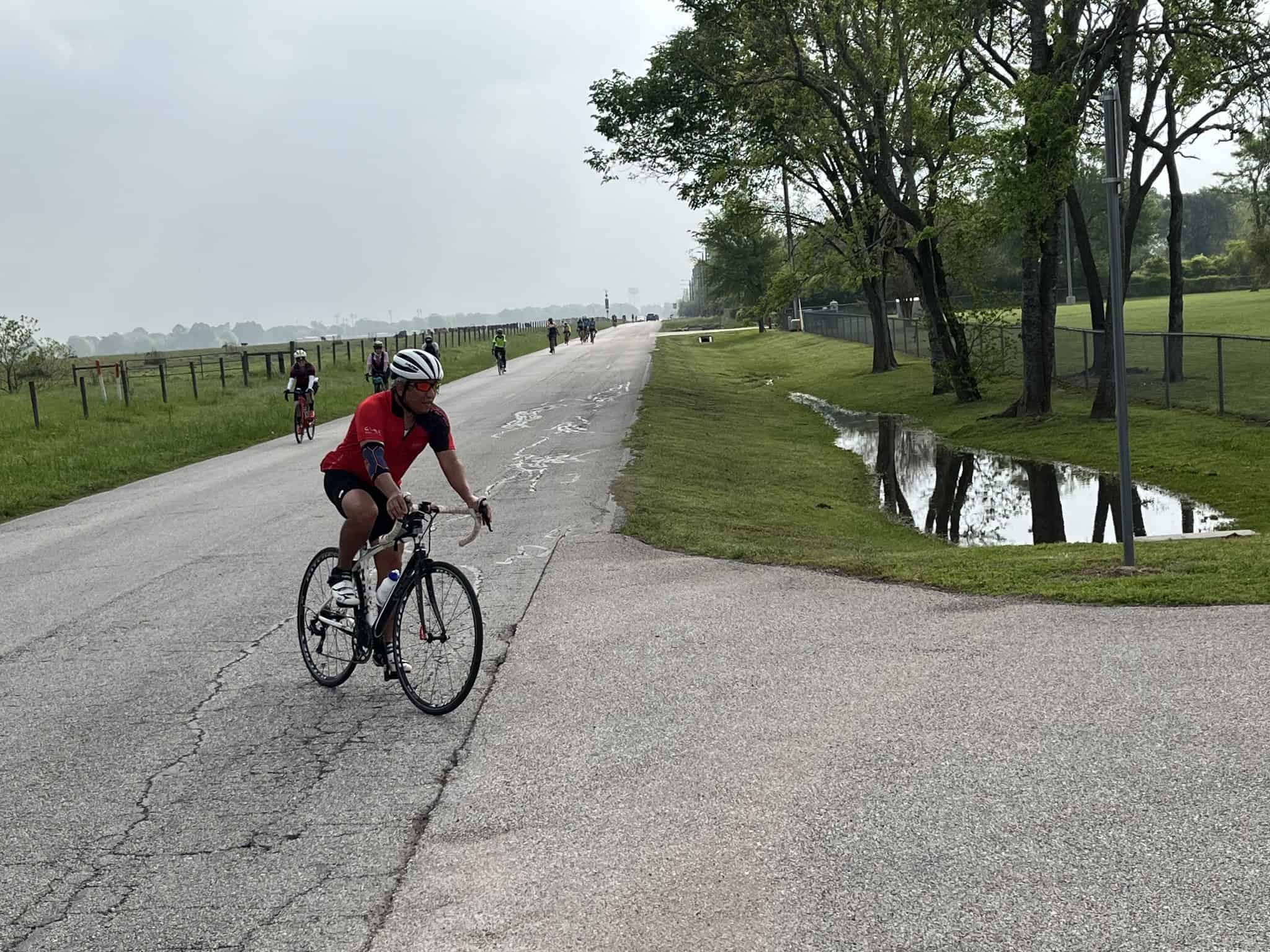 Kids riding bikes along a scenic trail on a cloudy day, promoting outdoor cycling activities.