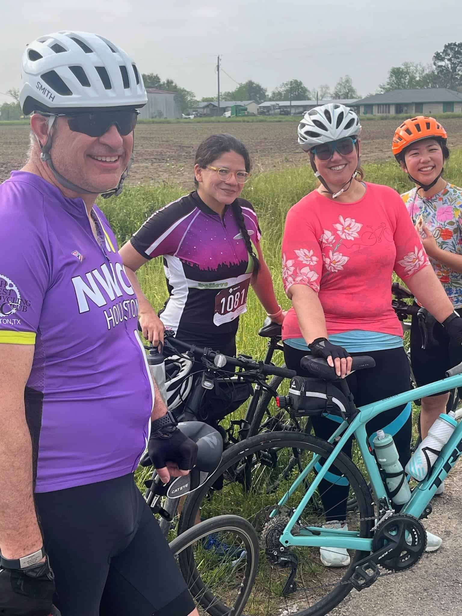 Vibrant group of cyclists enjoying a ride outdoors with scenic rural background, showcasing Bluebonnet Express biking event.