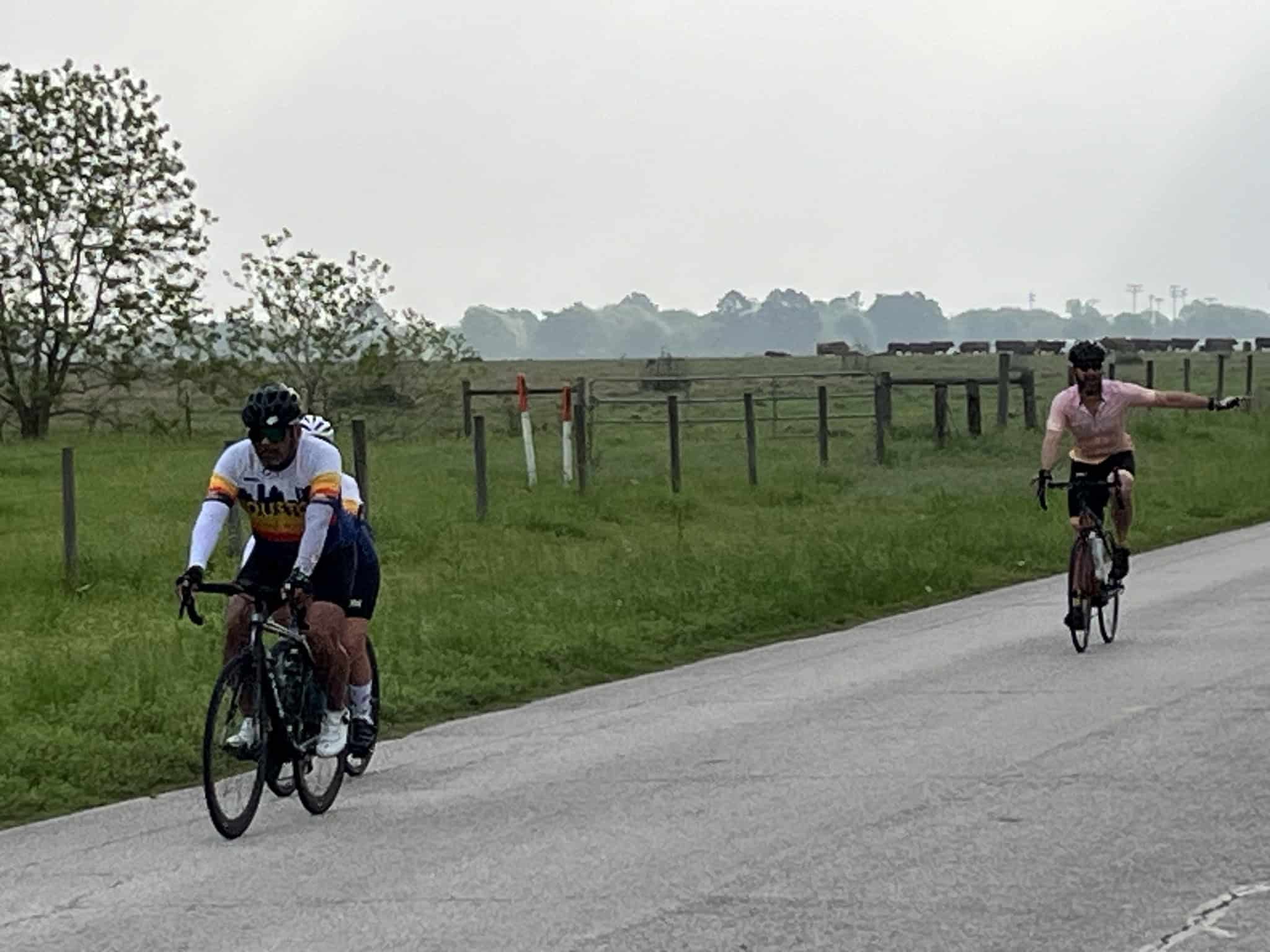 Cyclists riding on scenic rural road, Bluebonnet Express cycling event, Texas countryside, outdoor bike ride, scenic cycling route.