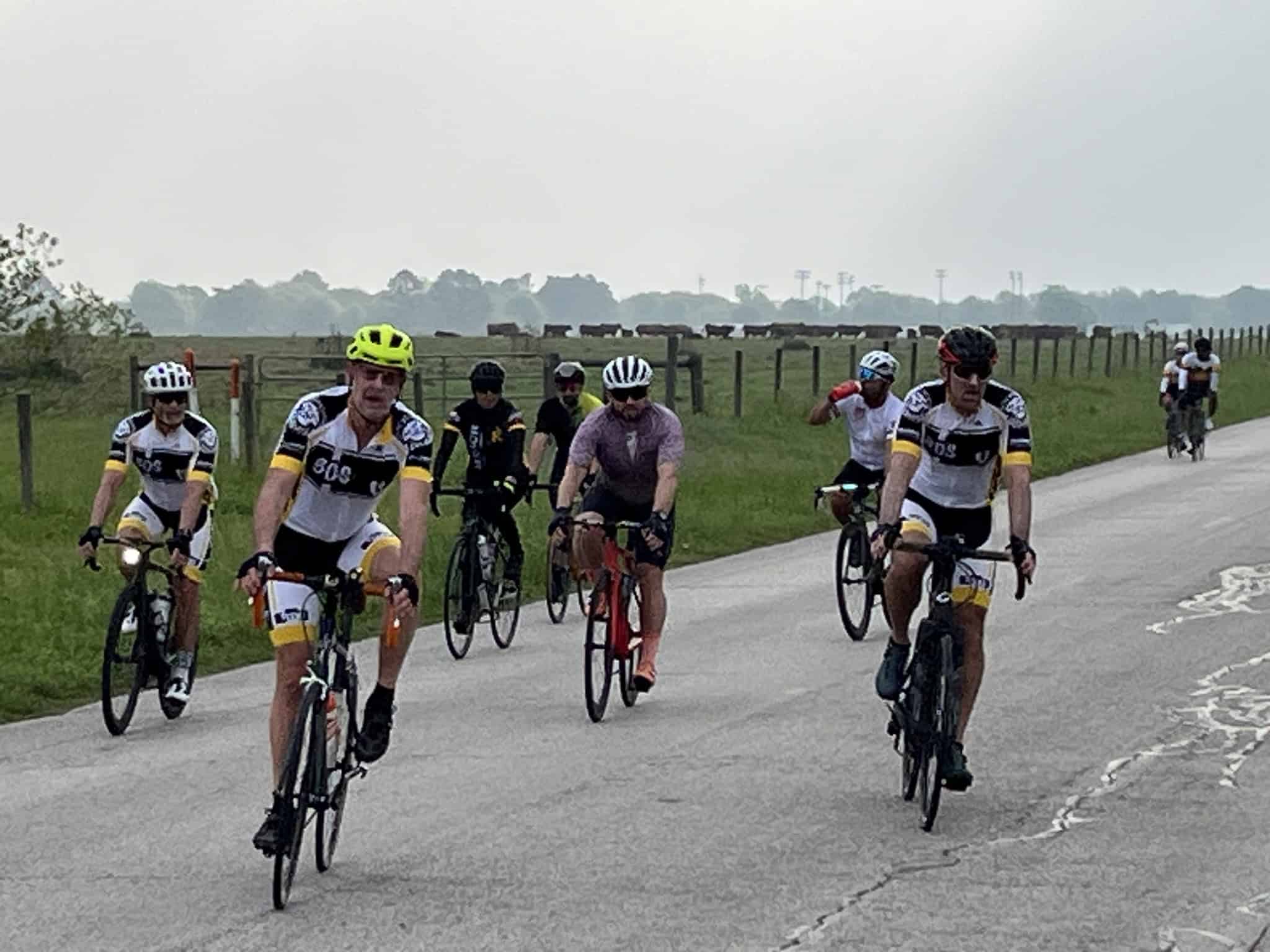 Cyclists riding along a rural road for Bluebonnet Express charity event in Texas.