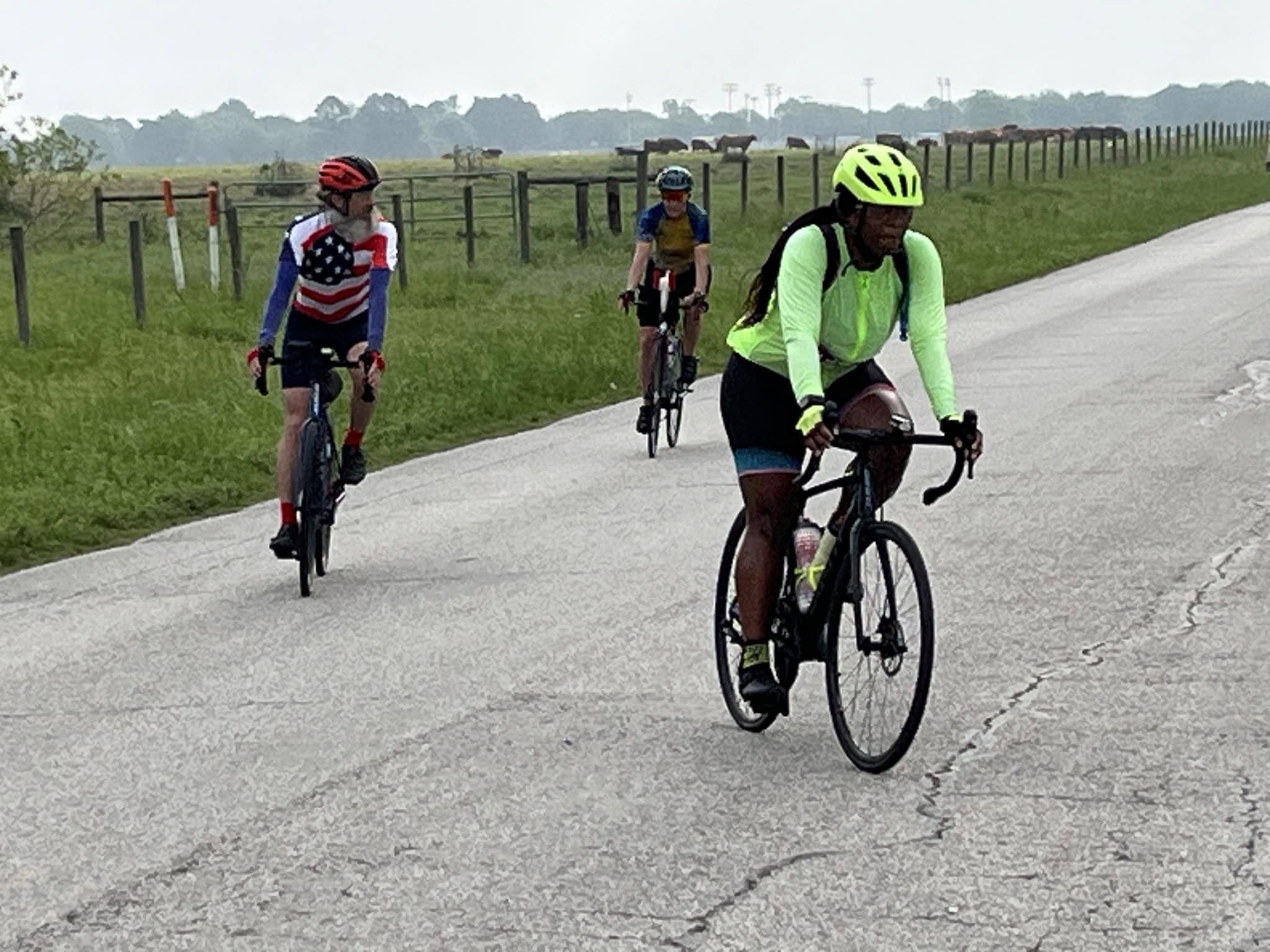 Bright neon green cycling jersey and black bike - Bluebonnet Express biking adventure.