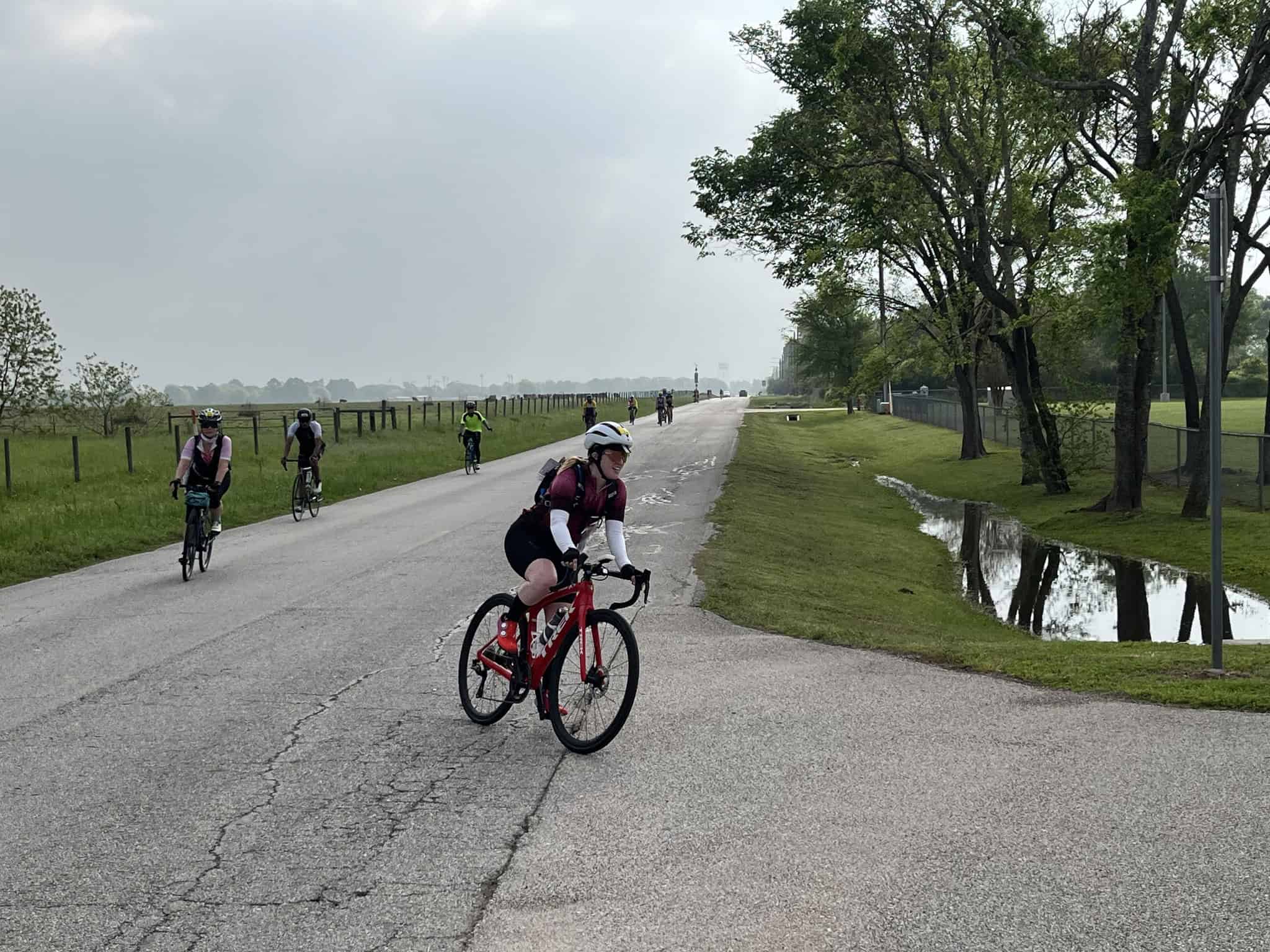 Pedestrians enjoying a scenic bike ride along a peaceful park trail in the countryside.