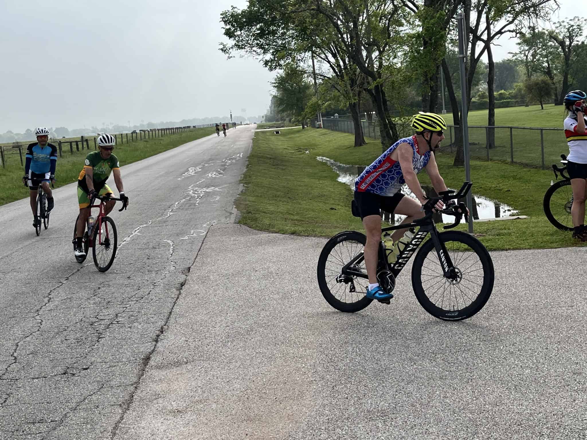 Riders participating in a cycling event on a scenic road, promoting outdoor activity and sportsmanship.