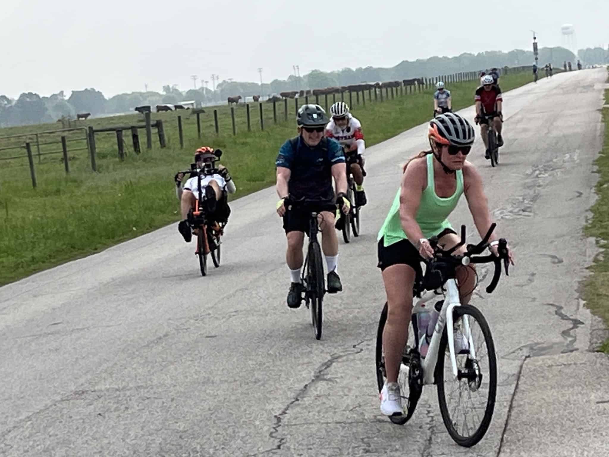 Scenic group bicycle ride on Bluebonnet Express trail through Texas countryside.