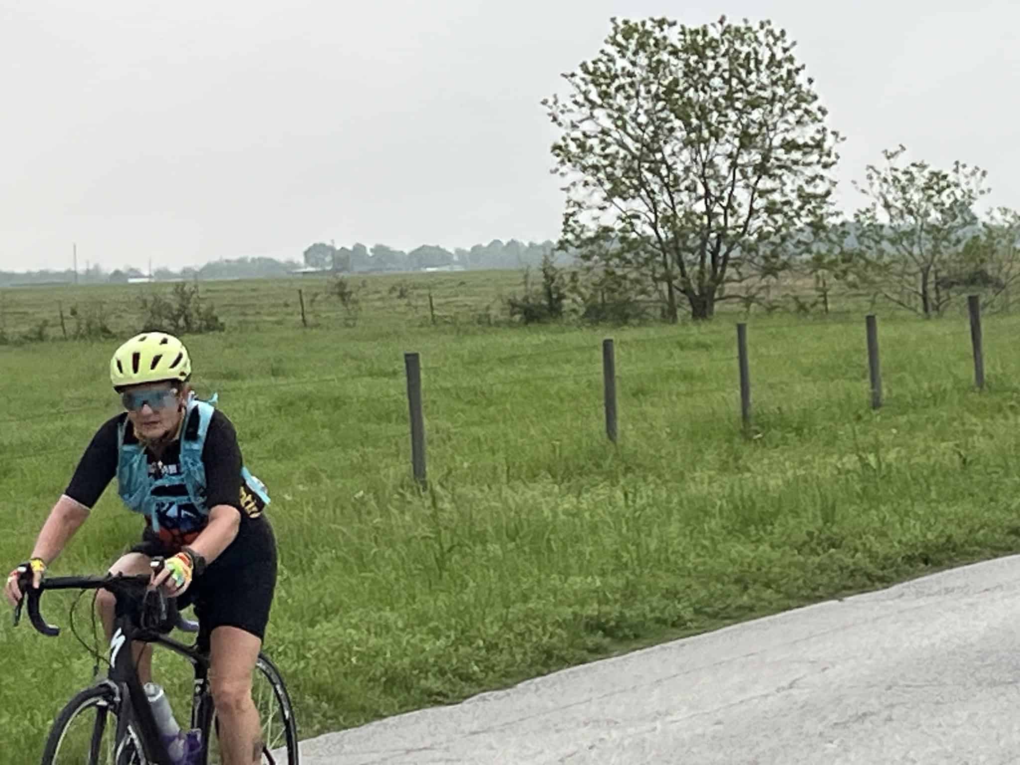 Bright yellow bicycle helmet and gear on cyclist enjoying scenic rural ride.