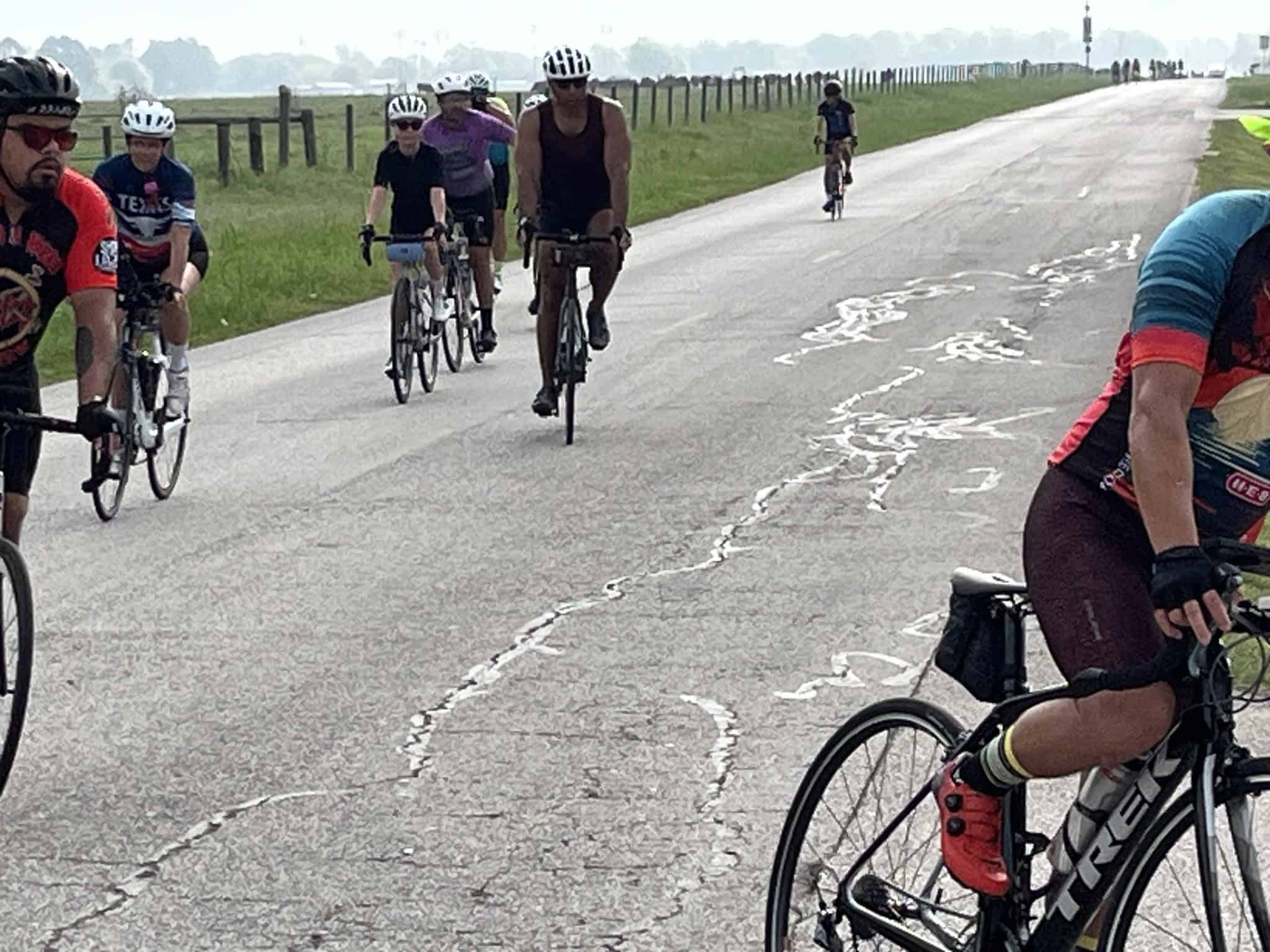 Riders participating in the Bluebonnet Express cycling event on a scenic open road.