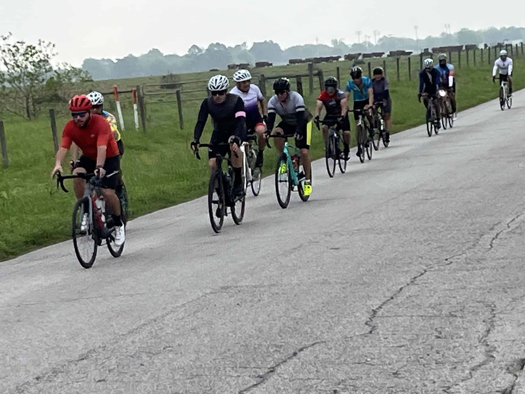 Cyclists riding on scenic rural road during Bluebonnet Express event, promoting outdoor fitness.