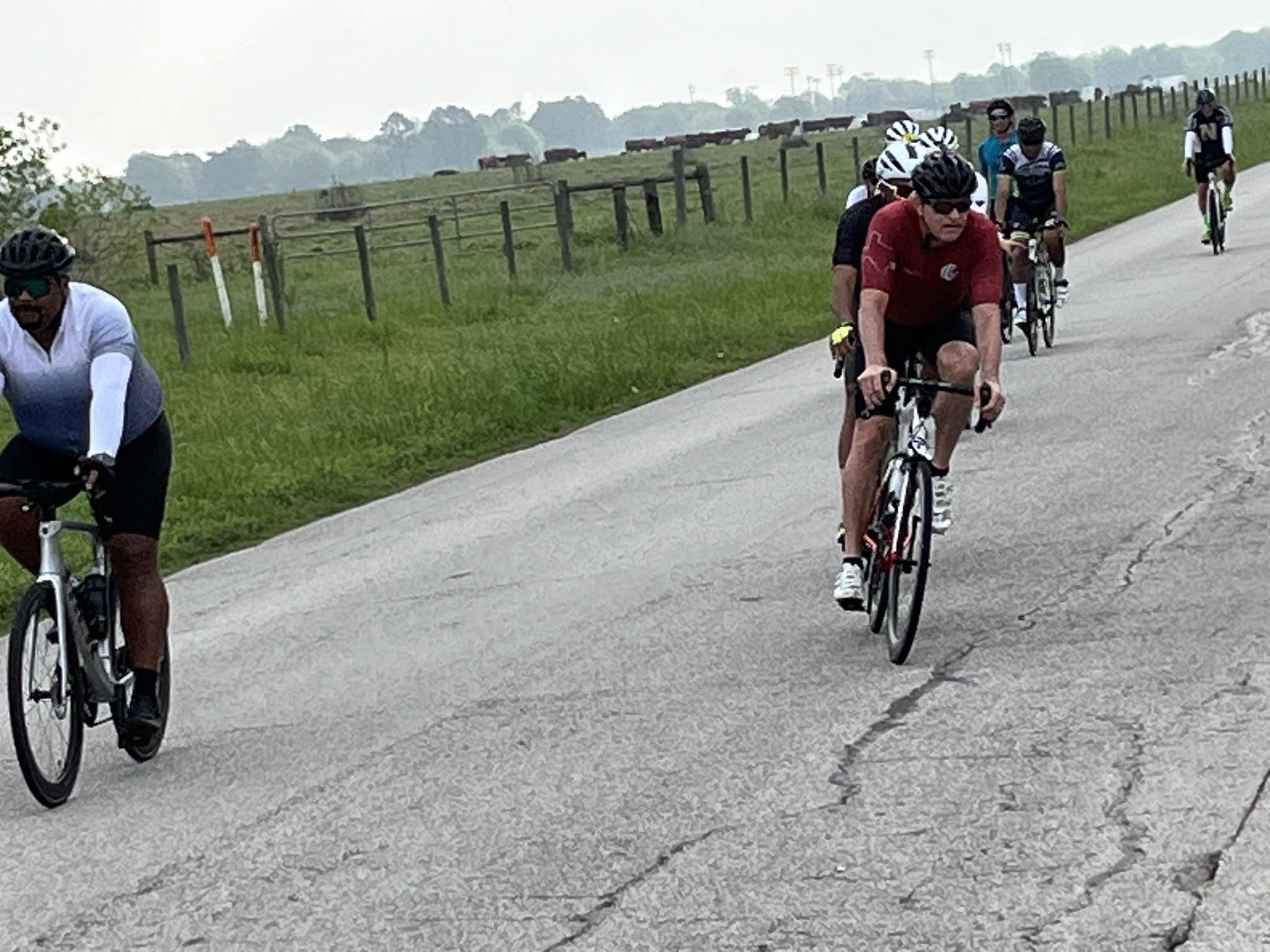 Riders cycling on scenic country road during Bluebonnet Express event.