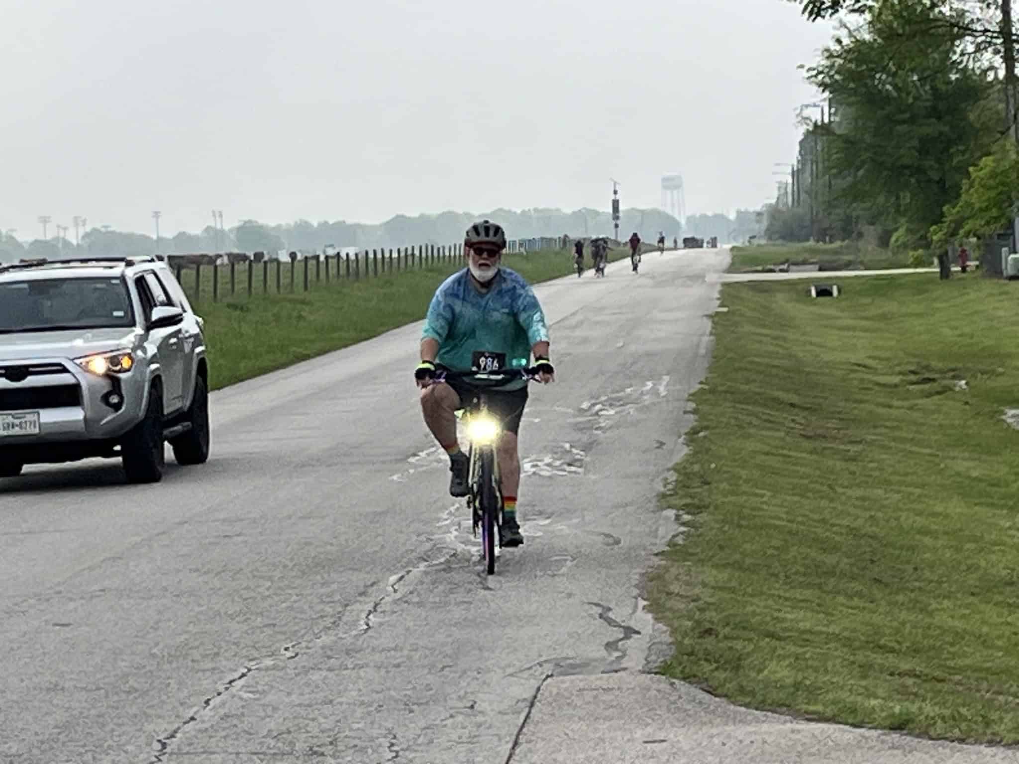 Cyclist on the Bluebonnet Express bike trail during a cloudy day in Texas.