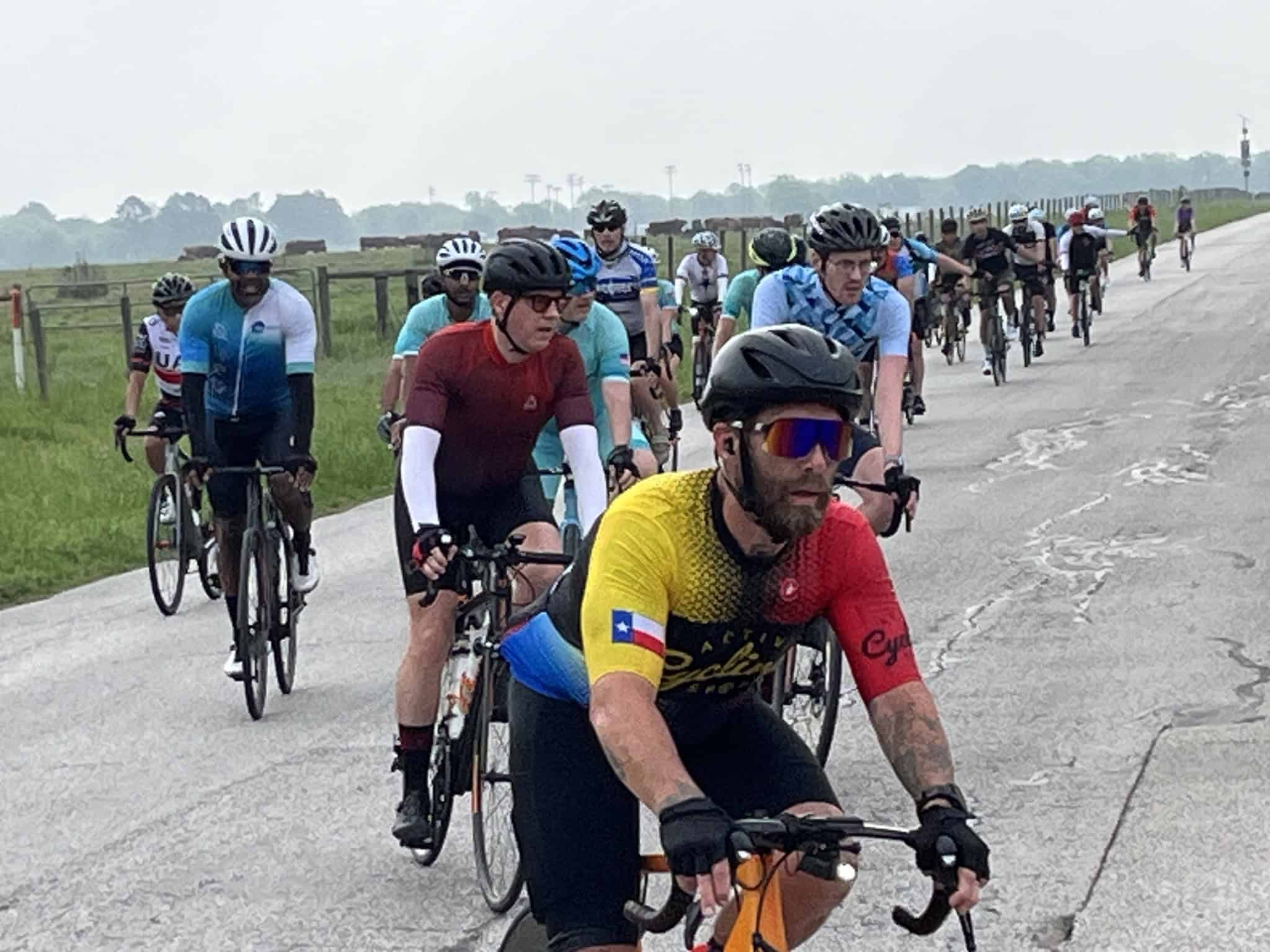 High-angle image of a group of cyclists riding on a rural road during a biking event.