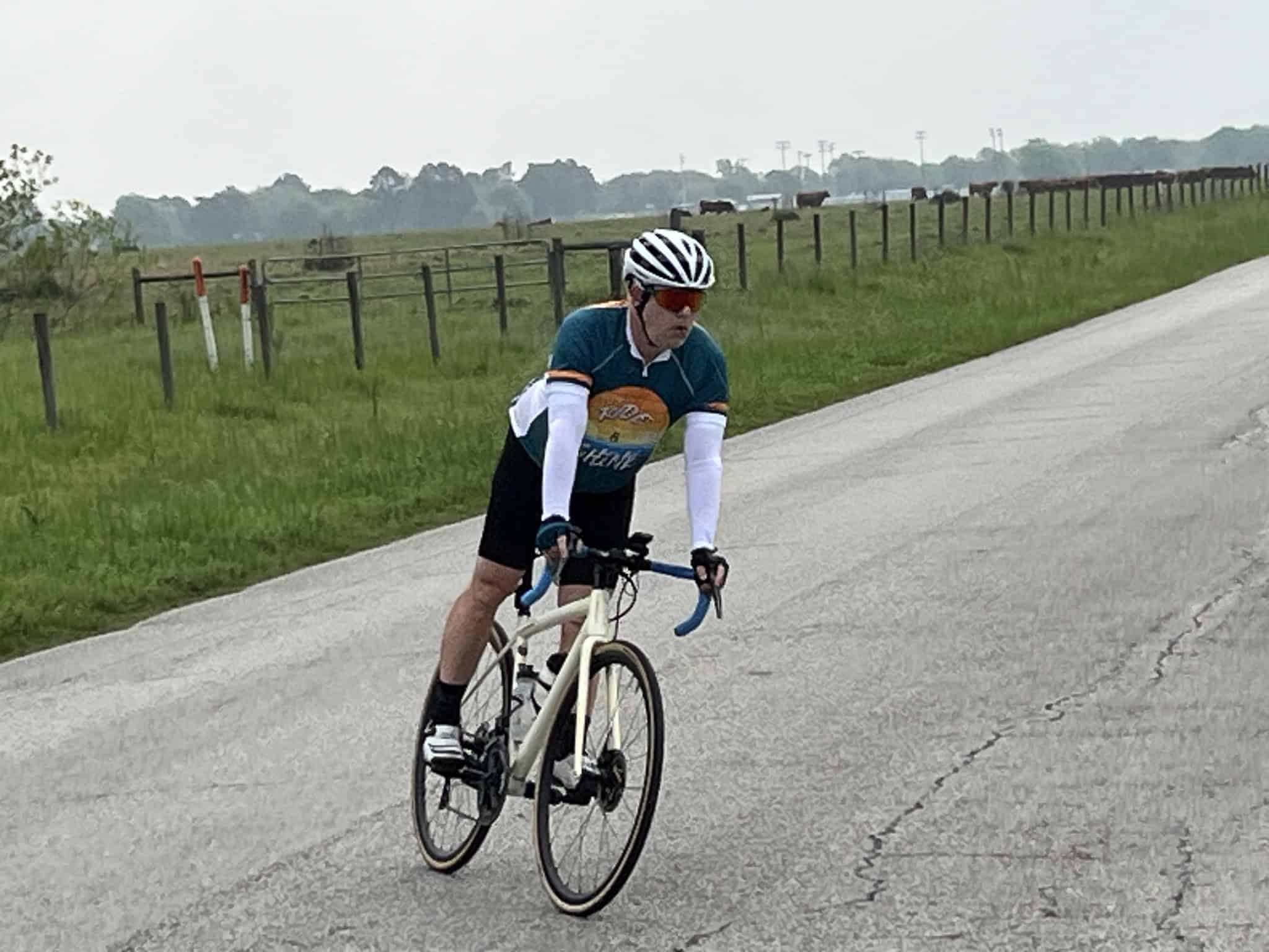 Cyclist riding on scenic rural road, promoting Bluebonnet Express bike tour event.