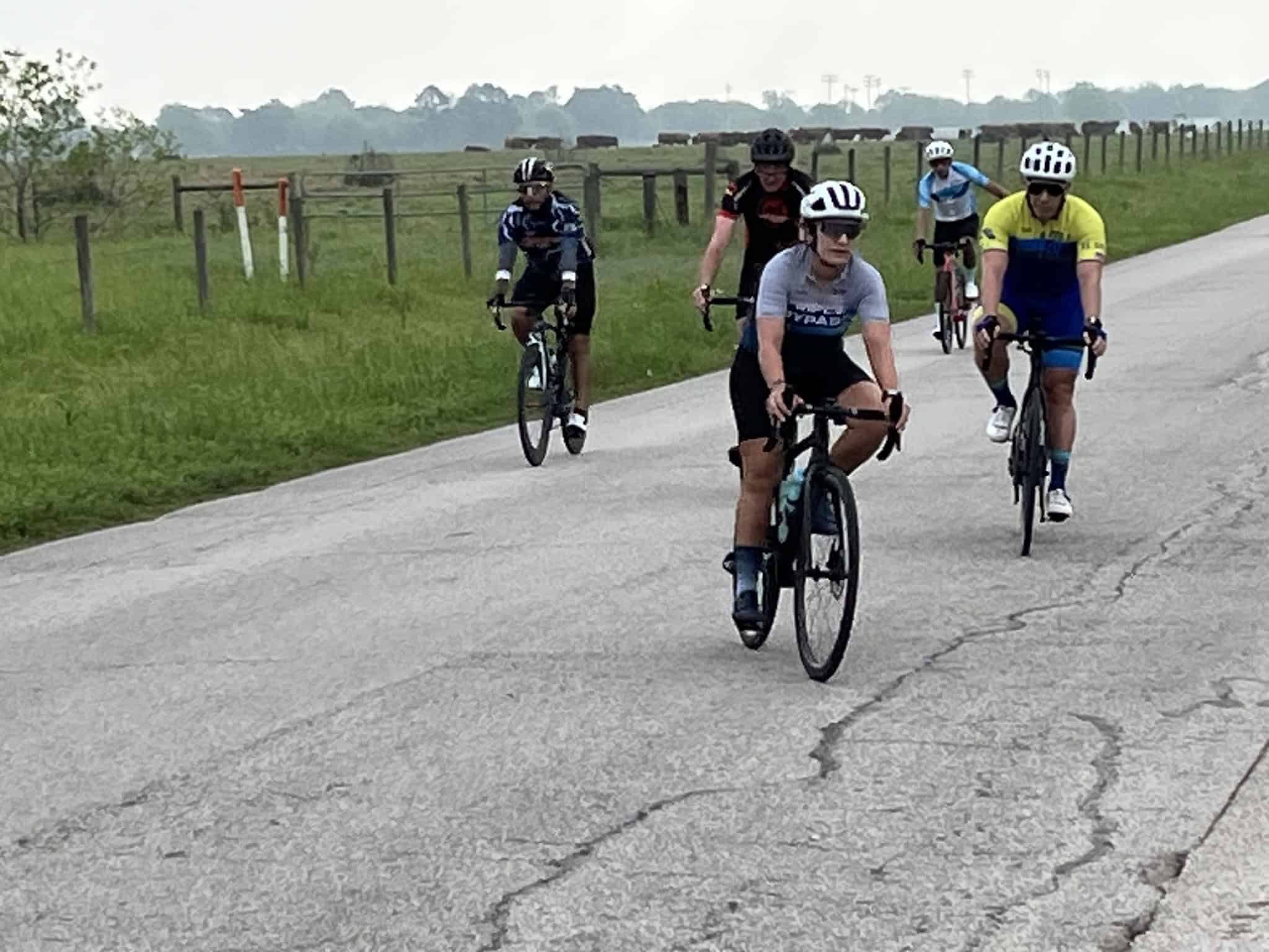 Cyclists riding on a countryside road as part of Bluebonnet Express event.