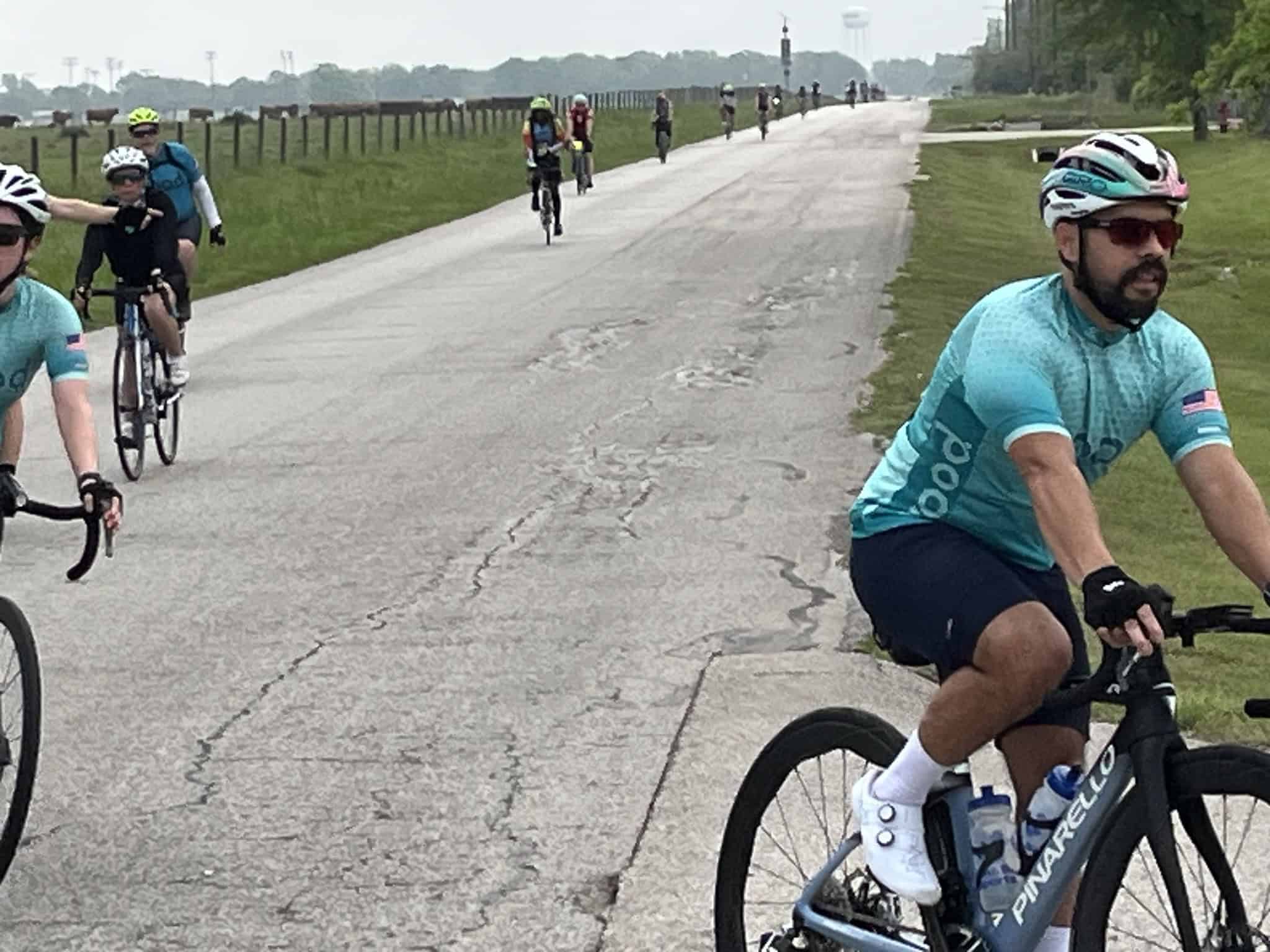Vibrant cyclist group on Bluebonnet Express bike trail, enjoying scenic ride in Texas countryside.