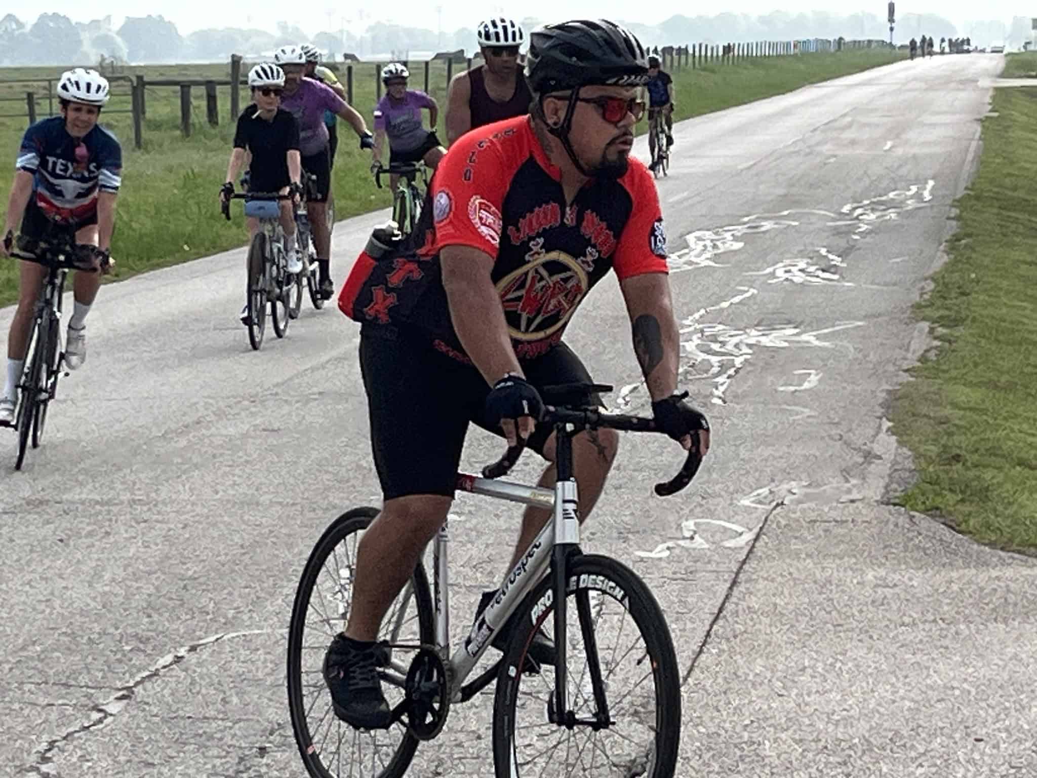 Vibrant group cycling along scenic route, promoting health and outdoor adventure with Bluebonnet Express bikes.