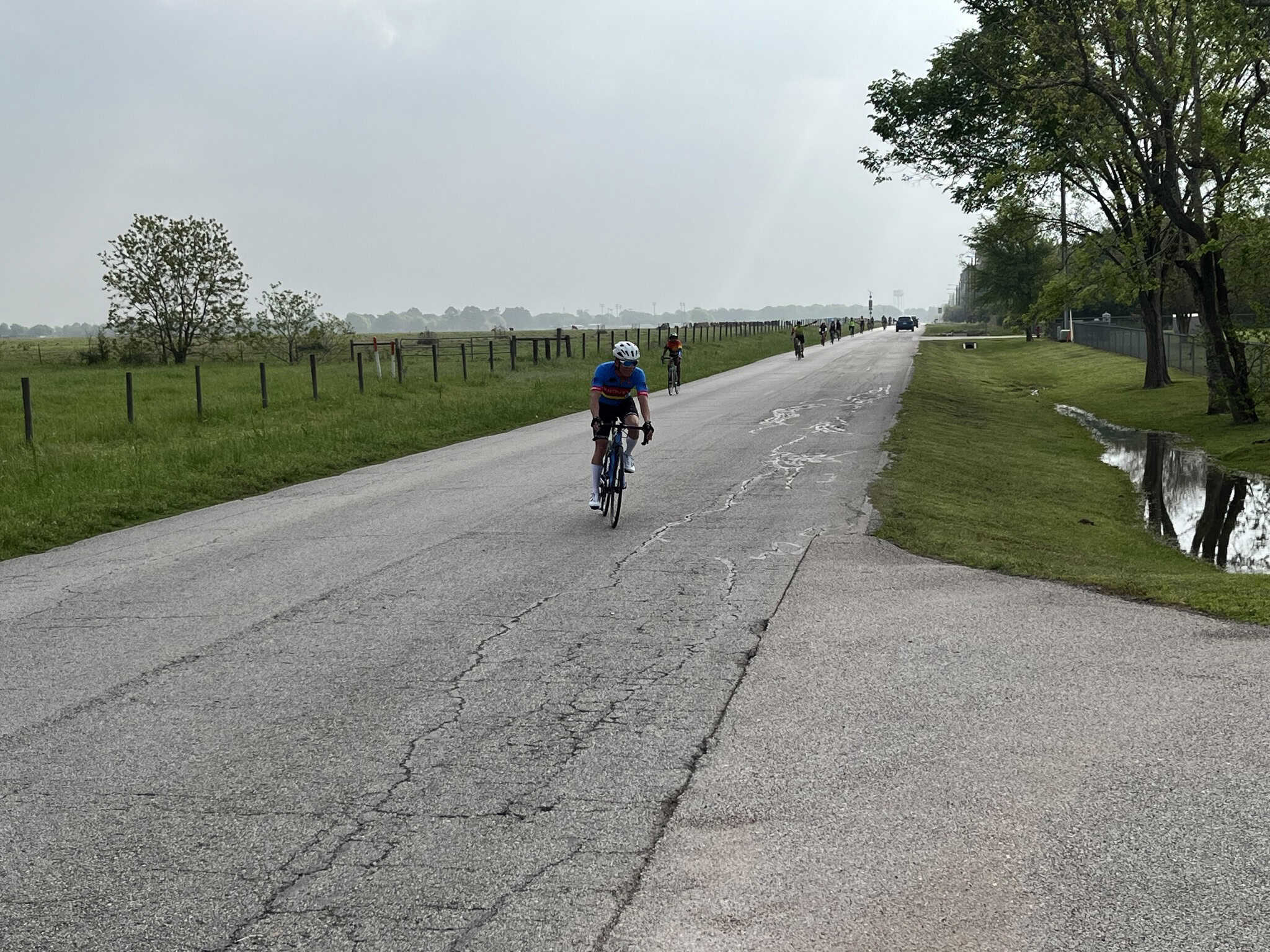 Bicycle rider cycling along the scenic countryside road, showcasing outdoor adventure and Texas bike trails.