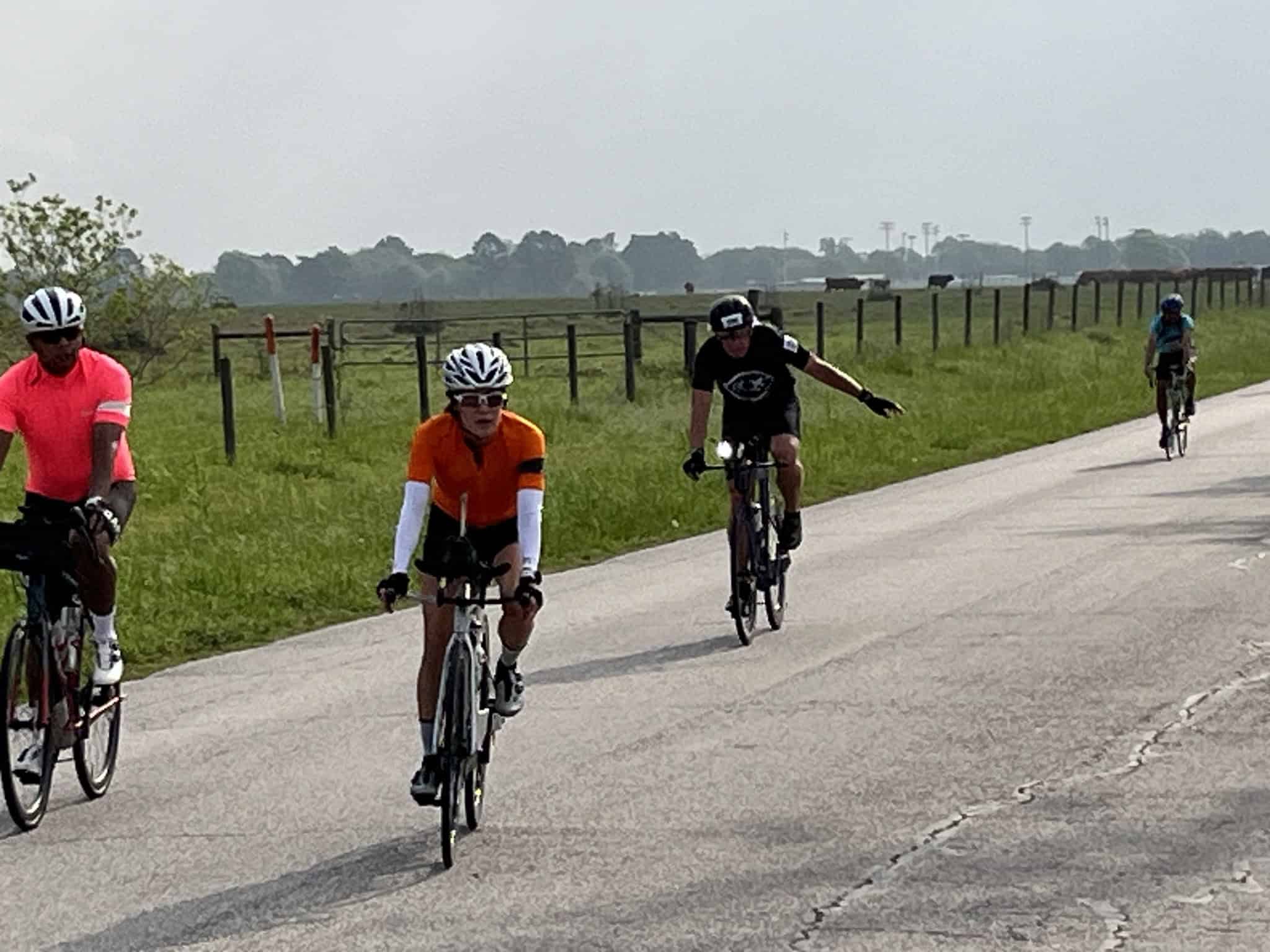 Vibrant cyclists riding on the Bluebonnet Express bike trail through scenic Texas countryside.