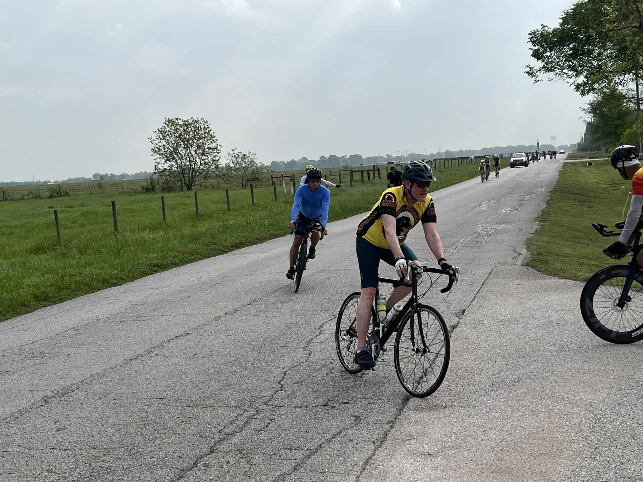 Cyclists riding on scenic countryside road during Bluebonnet Express event, enjoying cycling tour.