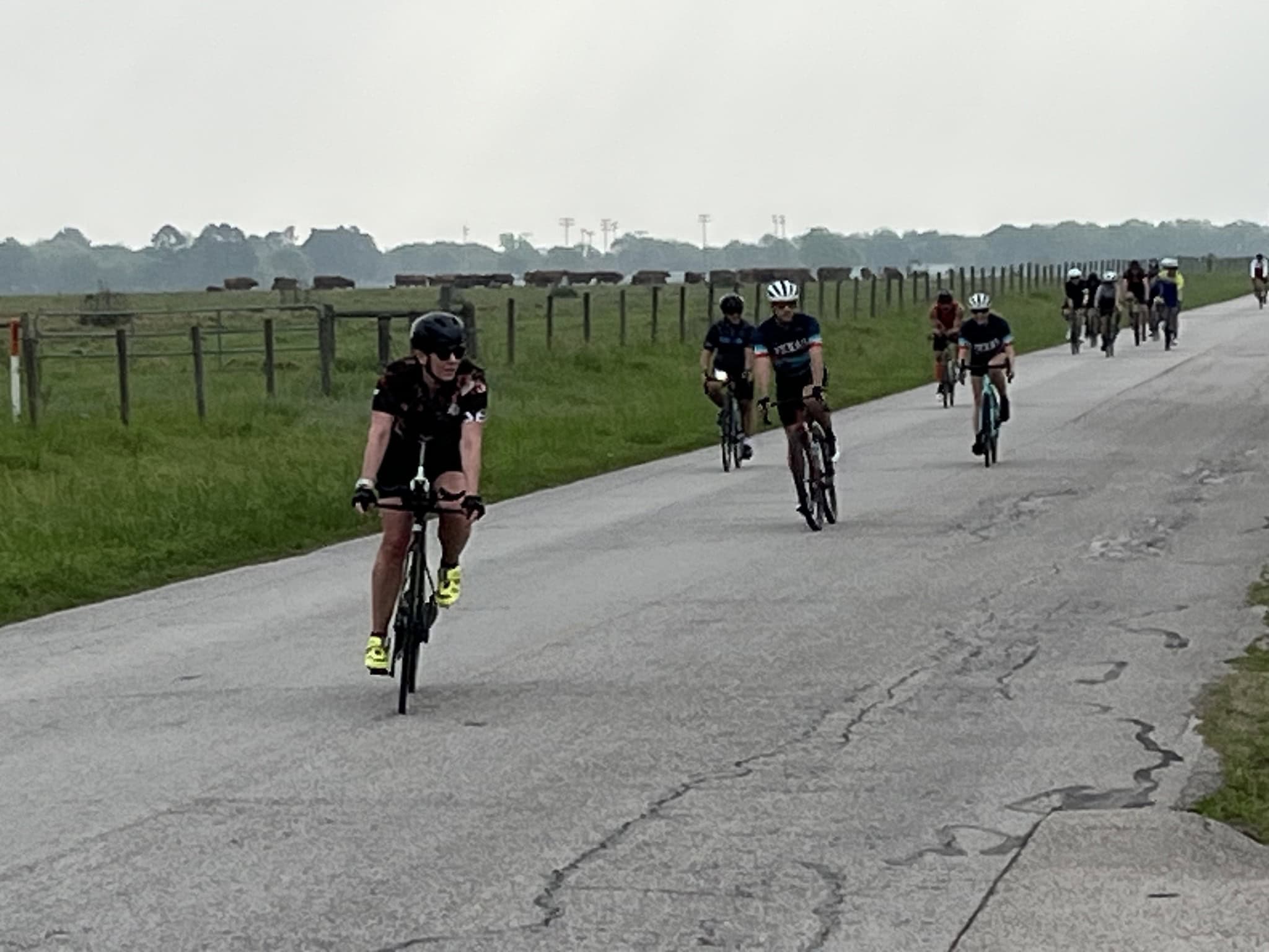 Bicycle riders enjoying a scenic outdoor ride on a rural country road in Texas.