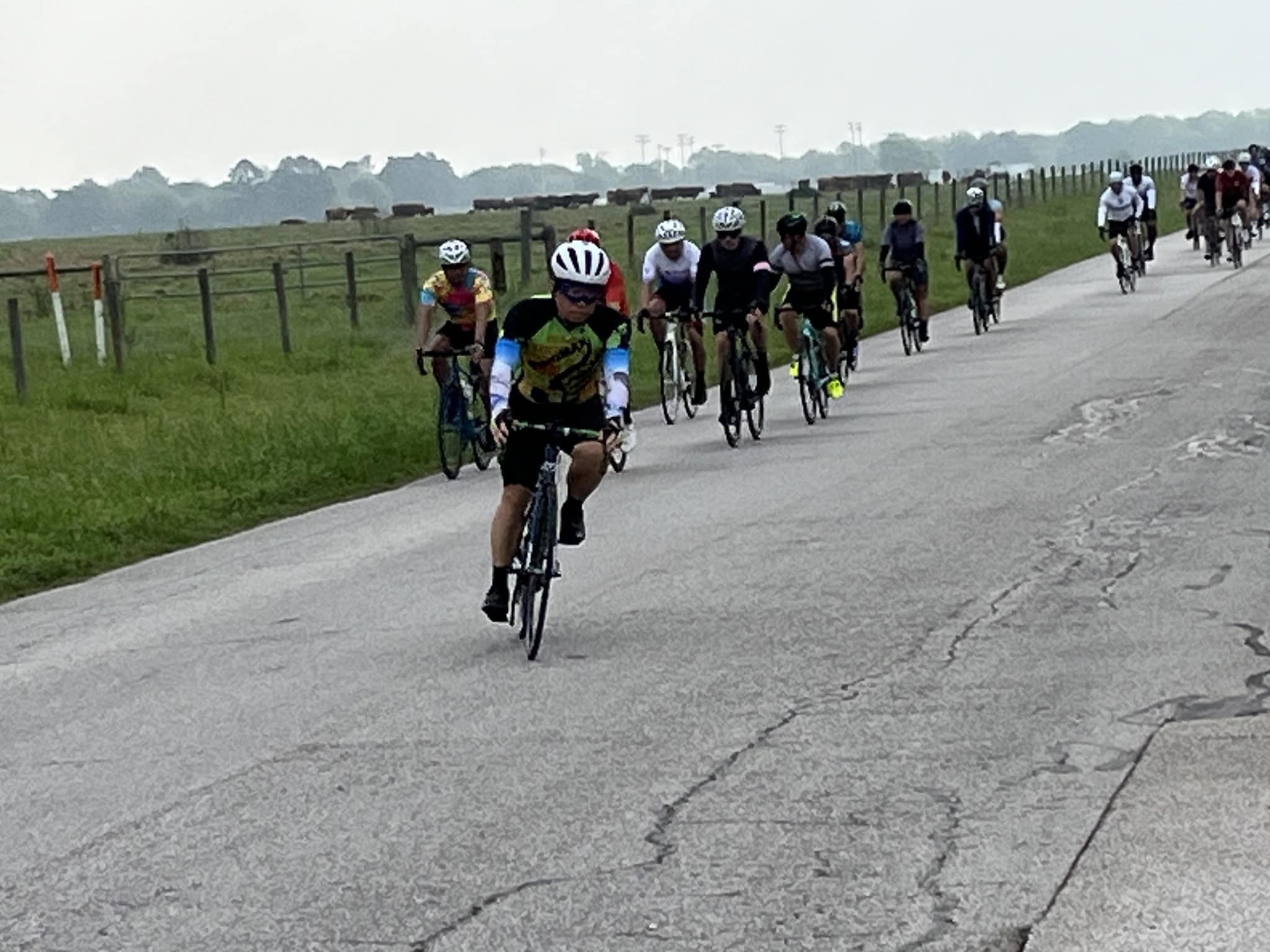 Cyclists riding on a rural road during the Bluebonnet Express event in Texas.
