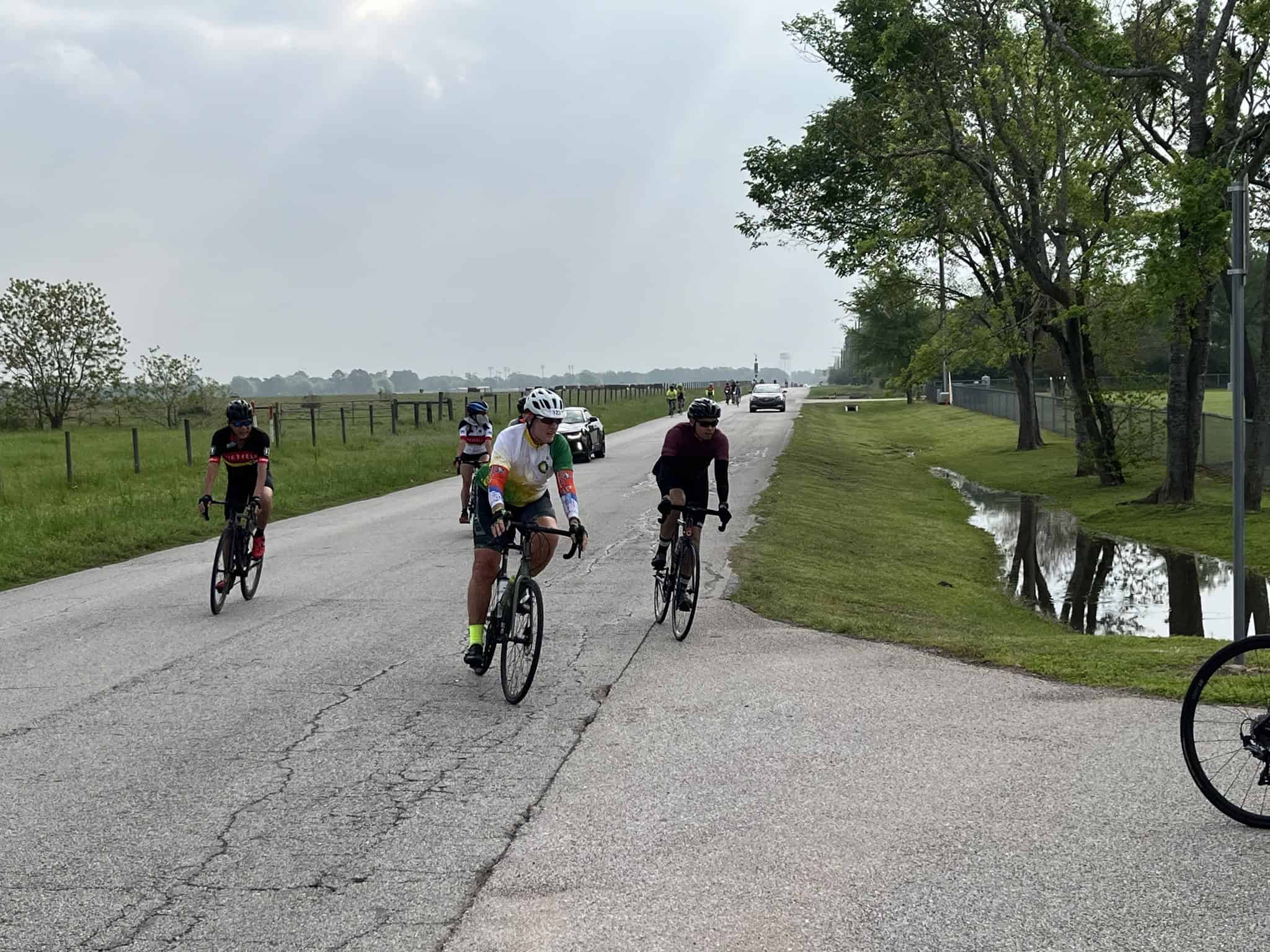 Bicycle riders cycling along scenic countryside road in Texas, featuring Bluebonnet Express event.