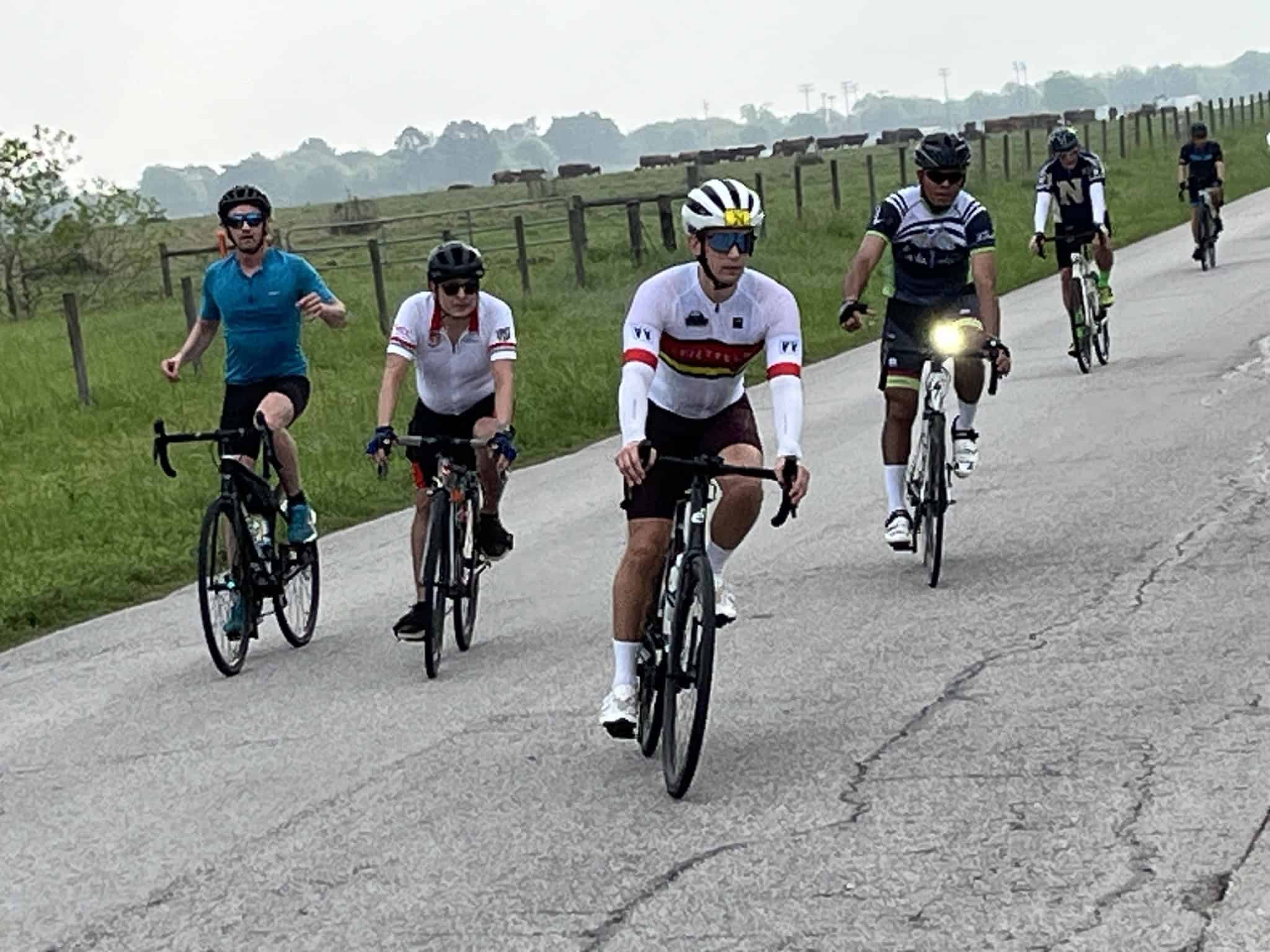 Cyclists riding on a scenic country road during a group bike rideイベント.