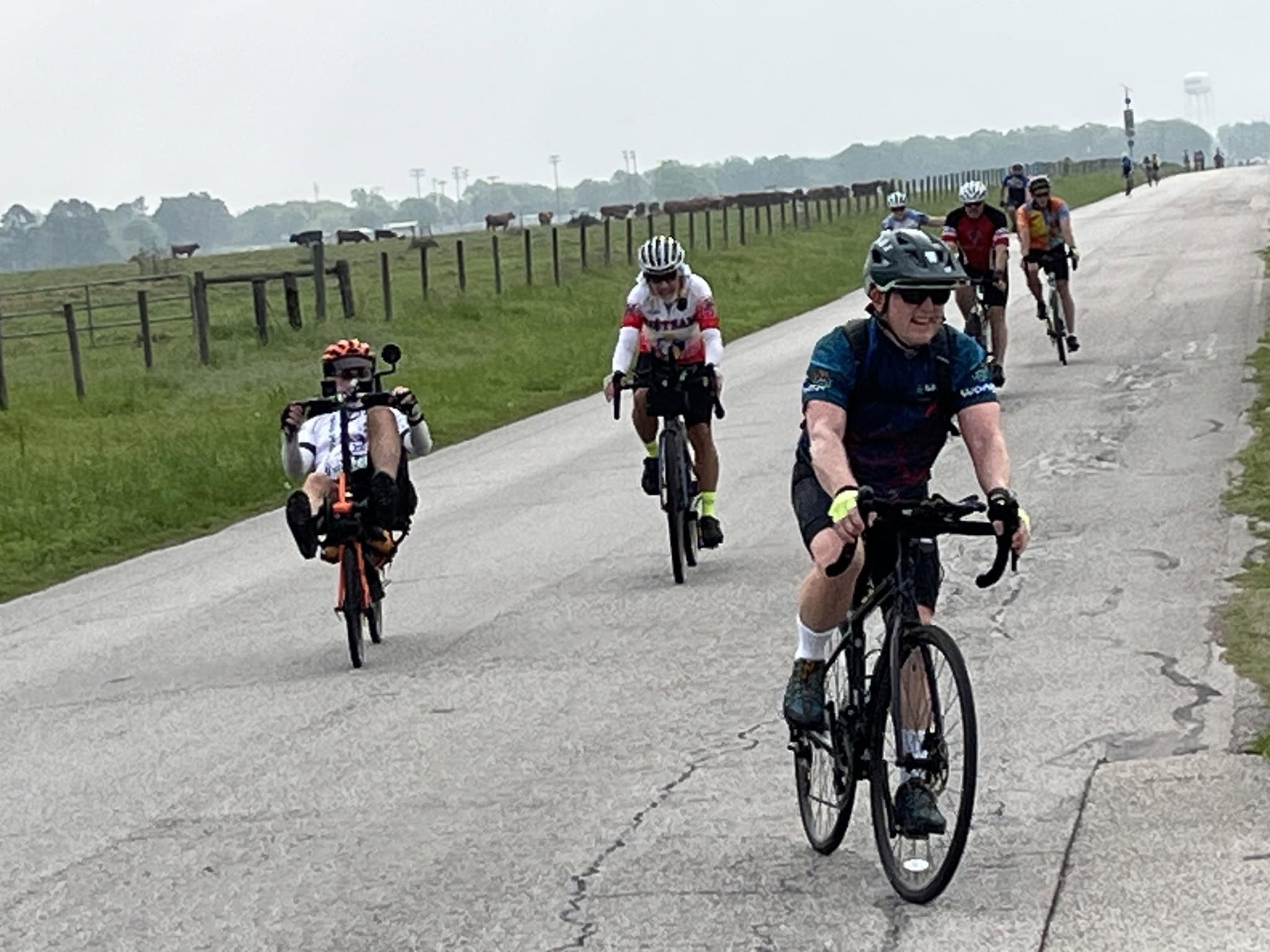 Cyclists riding on scenic rural road, participating in Bluebonnet Express bike event.