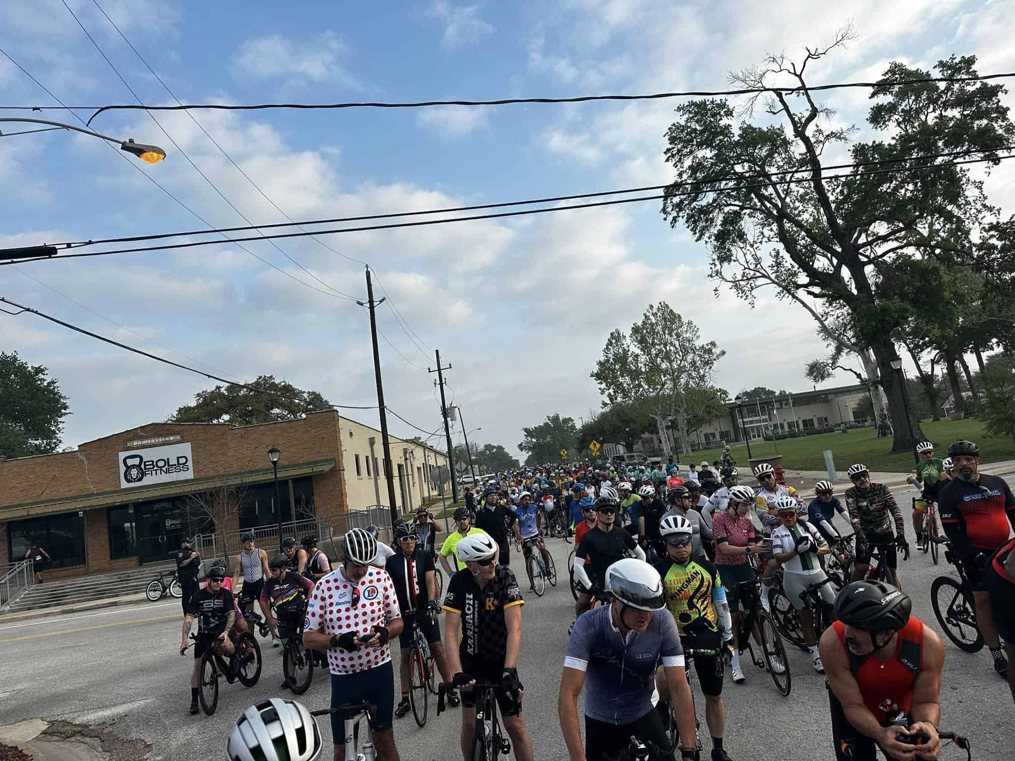 Bright blue sky with cyclists participating in Bluebonnet Express bike ride event near Bold Fitness.