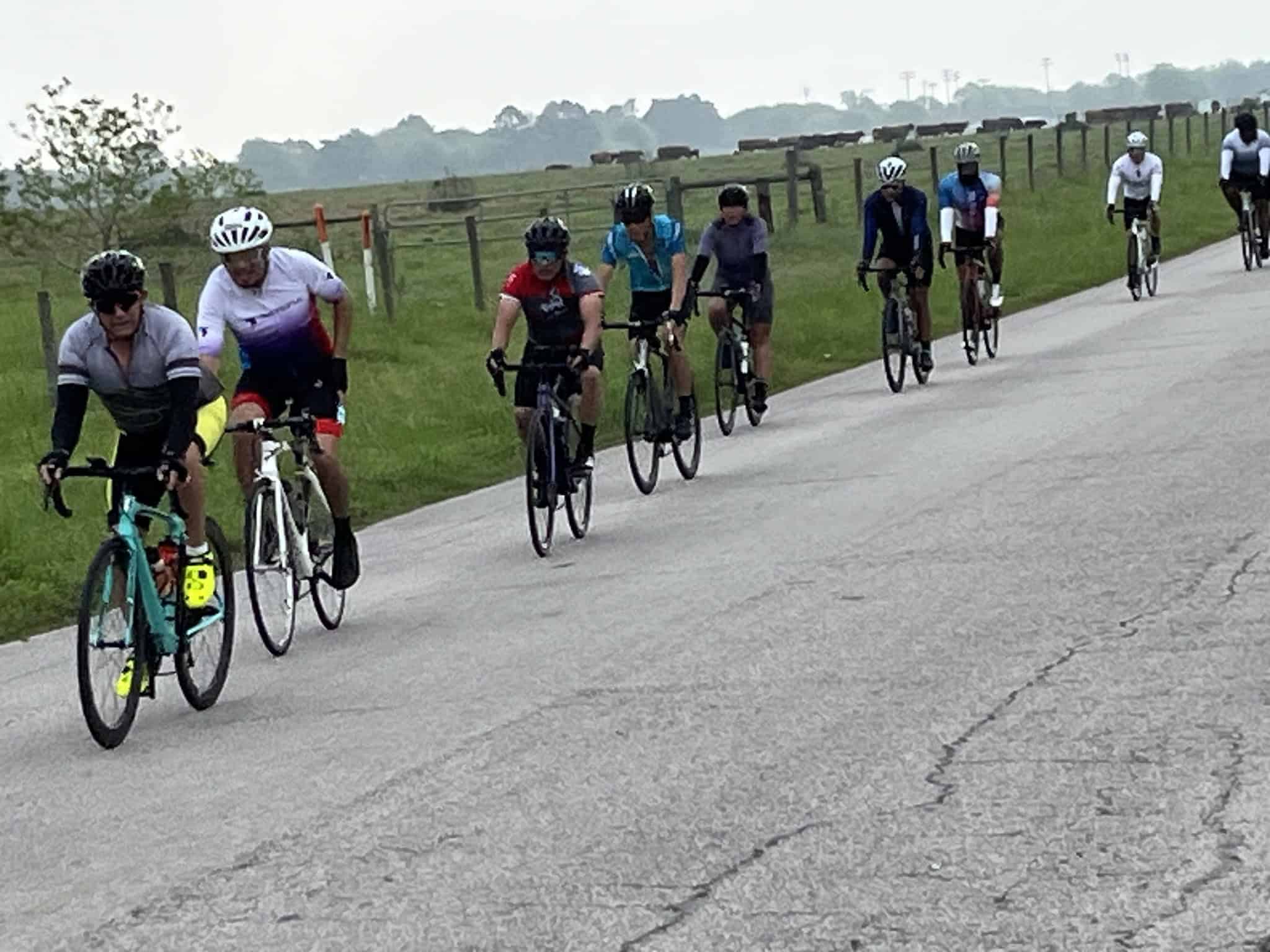 Cyclists riding together on a rural bike path in the Bluebonnet Express event.