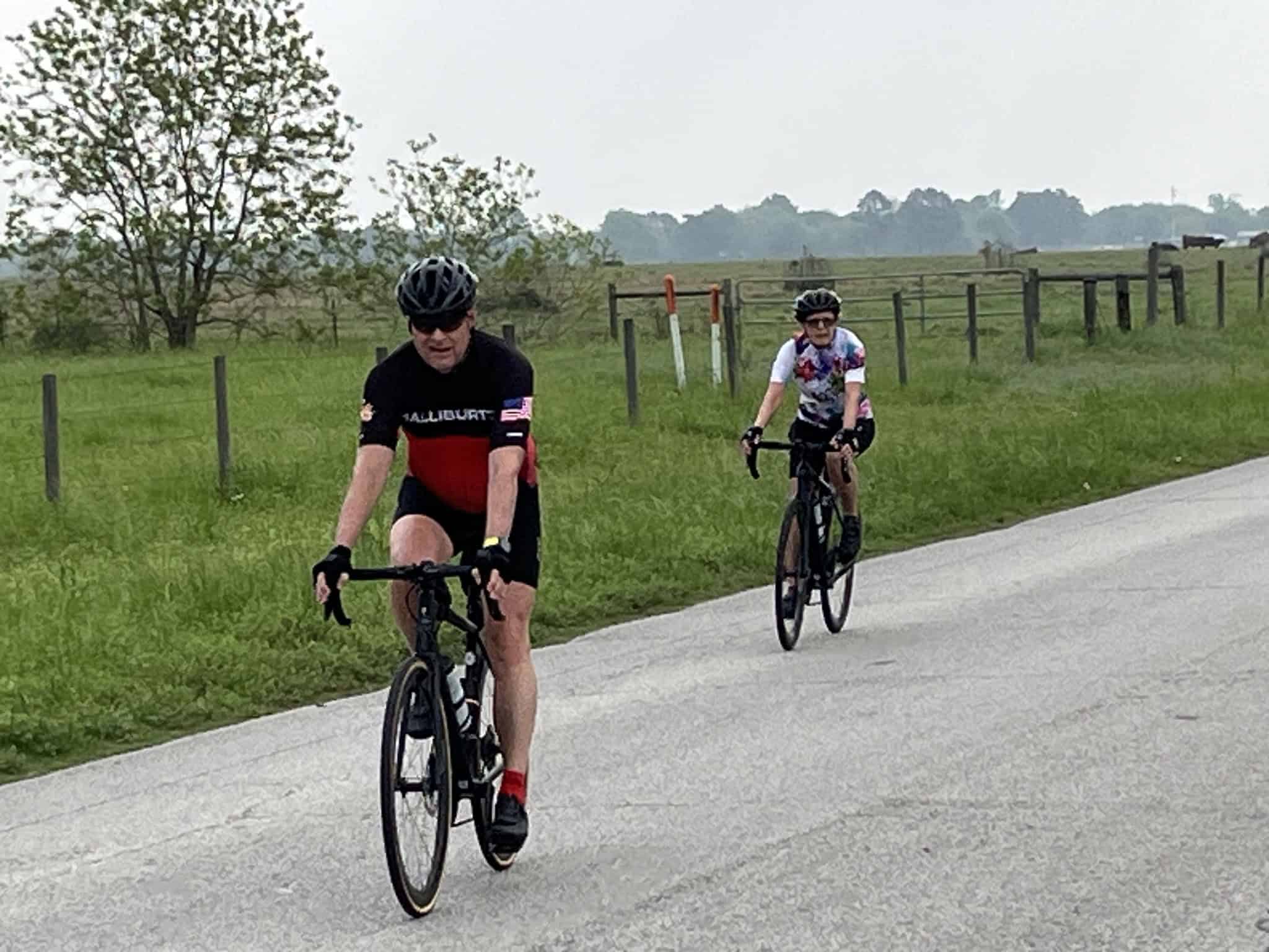 Outdoor cycling on Bluebonnet Express rural road featuring cyclists enjoying a scenic ride.